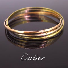 Trinity Three-Color Gold Rolling Bangle Bracelet by Cartier