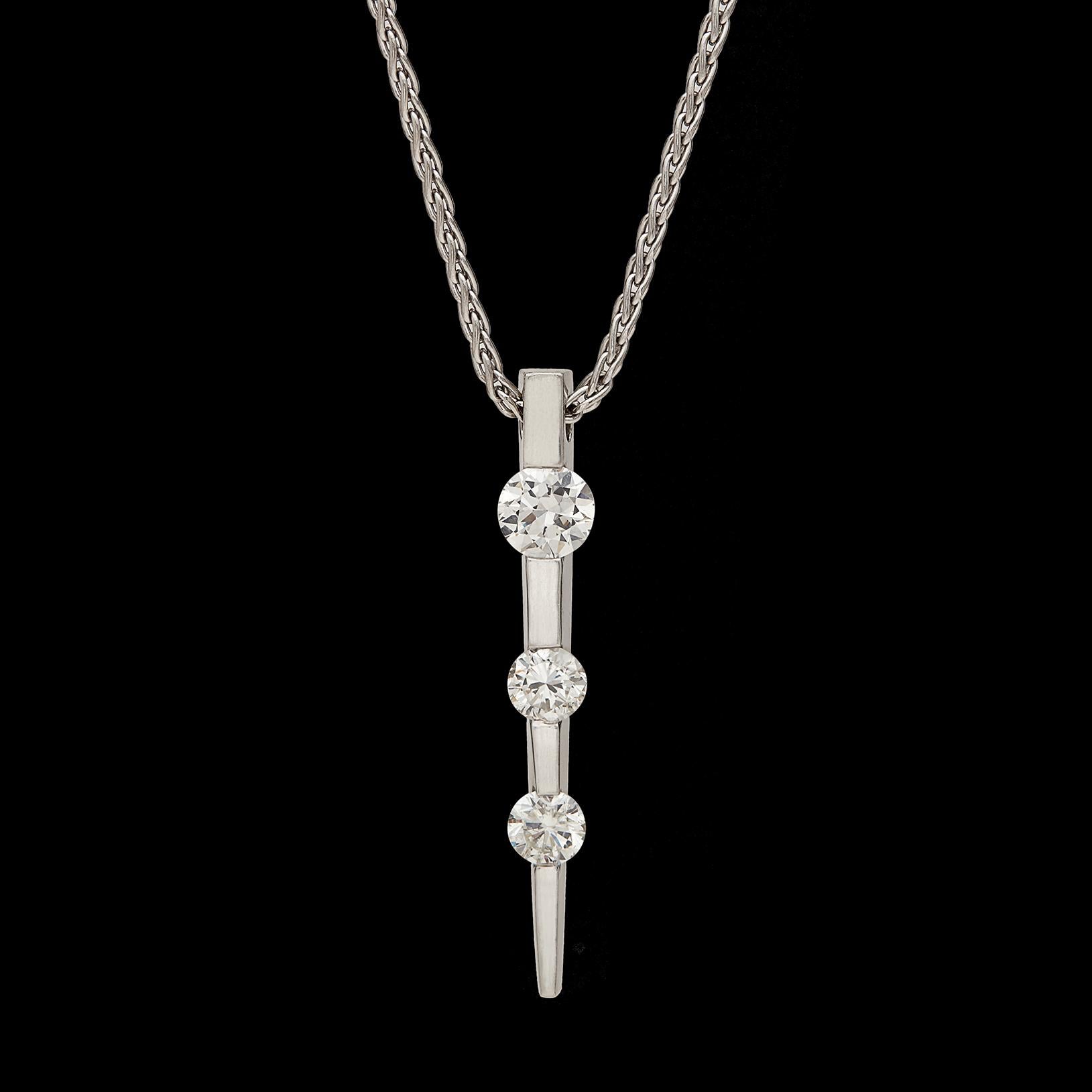 Express your eternal love with this 3-diamond pendant necklace. Designed in 14k white gold, the pendant is set with three graduating, transitional round brilliant-cut diamonds averaging G-H color VS-SI clarity, together weighing 1.45 carats, and