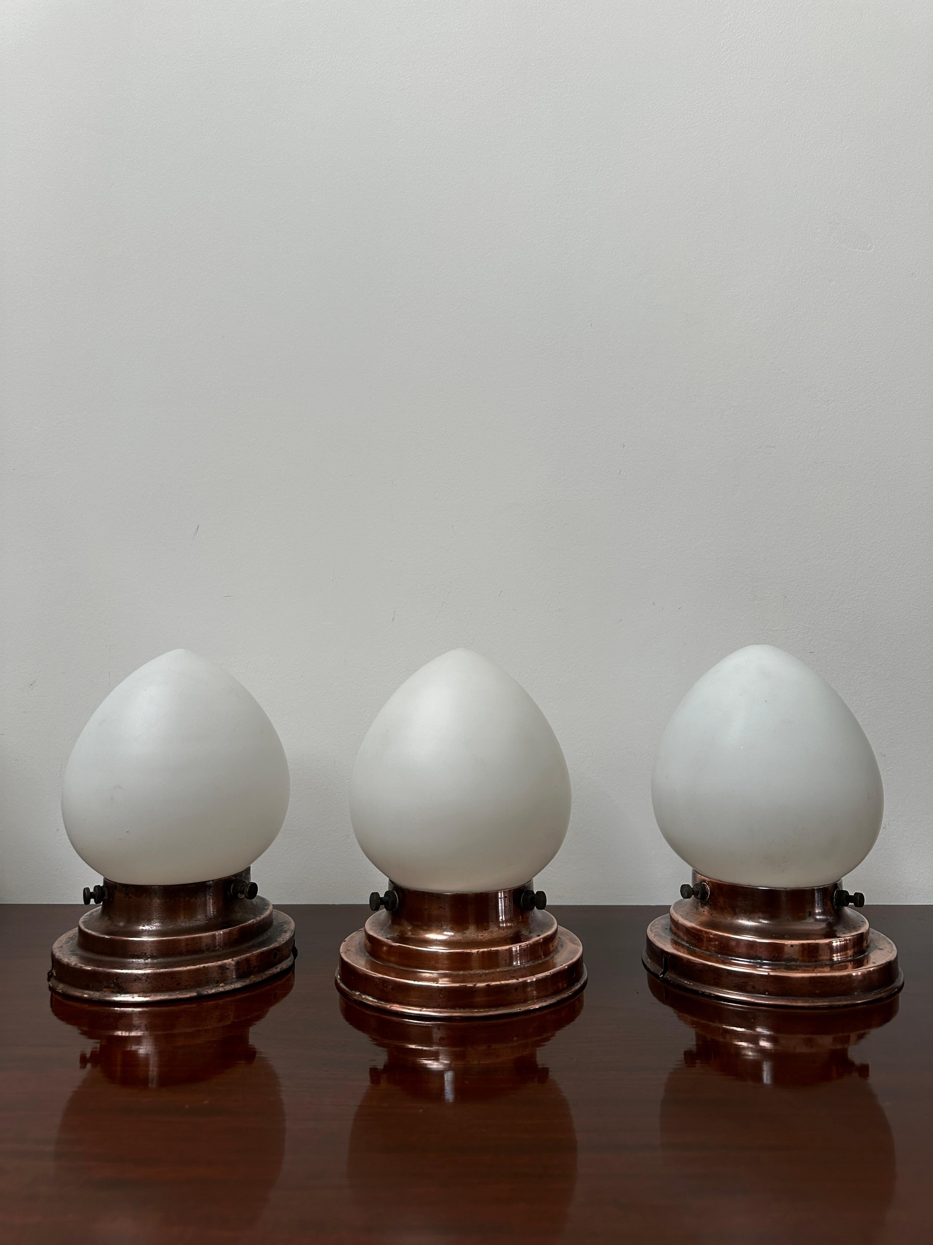 - An original and extremely rare trio of opaline Bauhaus ceiling pendants by Kandem, Germany circa 1920.
- The egg shaped opaline shades are of real quality with remnants of the Kandem 349 mark, each with matching flush mounted galleries