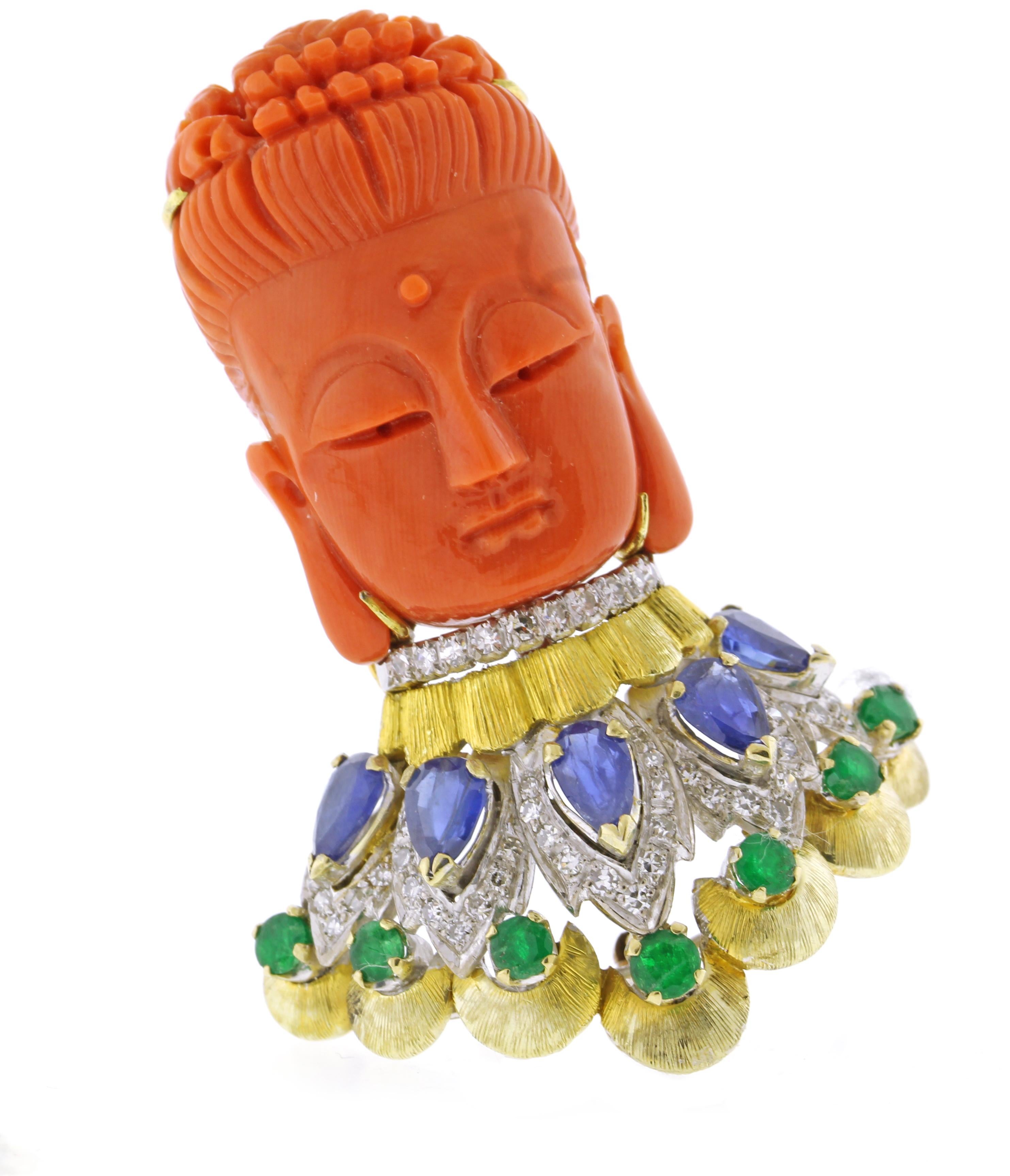 From Trio, a meticulously carved coral Buddha brooch, set with diamonds sapphires and emeralds.
♦ Designer: Trio
♦ Metal: 14karat white and yellow gold
♦ Circa 1980s
♦ 2 inches high
♦ 66D=.60
♦ Sapphires=.45 carats
♦ 7Emeralds=.45 carats
♦