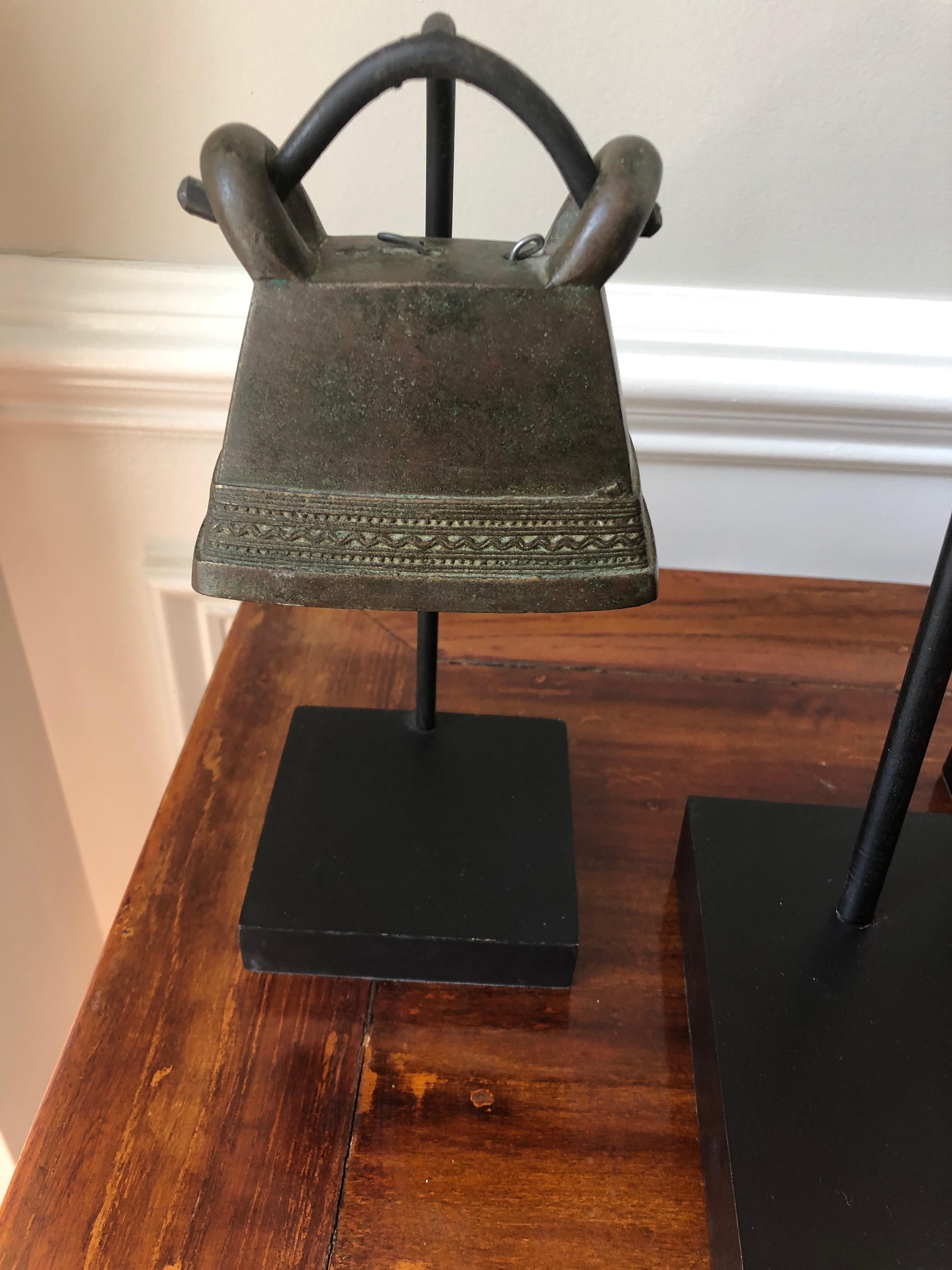 A great looking collection of 3 19th century antique Thai brass bells with lovely detailing and shapes, displayed on simple custom black stands. 
The smaller bells are 5.5 w x 3 D x 8 H and 3.5 x 3.5 x 9.25 H.