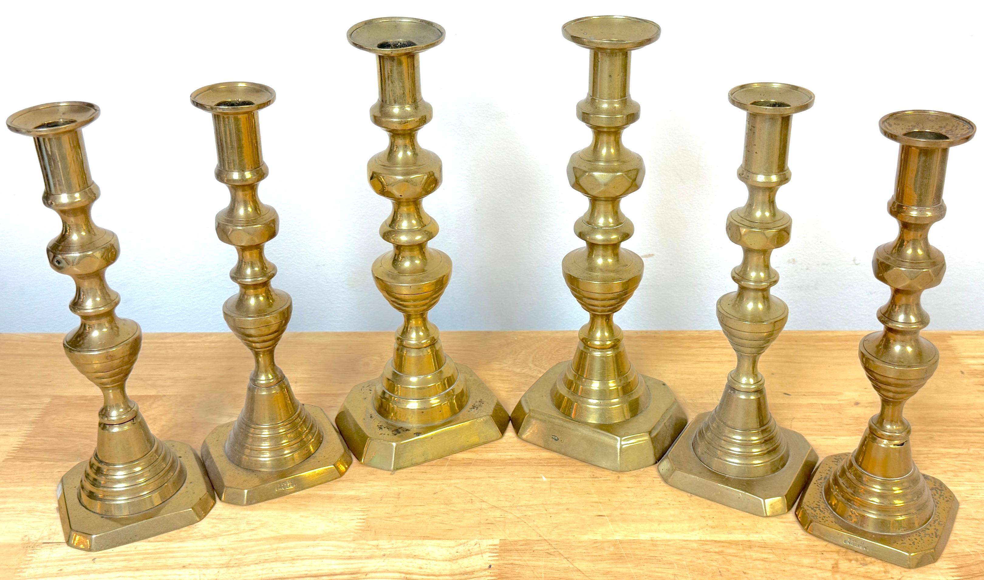 A handsome and versatile grouping of three pairs of antique English brass beehive candlesticks, dating to the late 19th century. This trio forms an instant collection or an elegant graduated table setting, showcasing the refined balance and symmetry