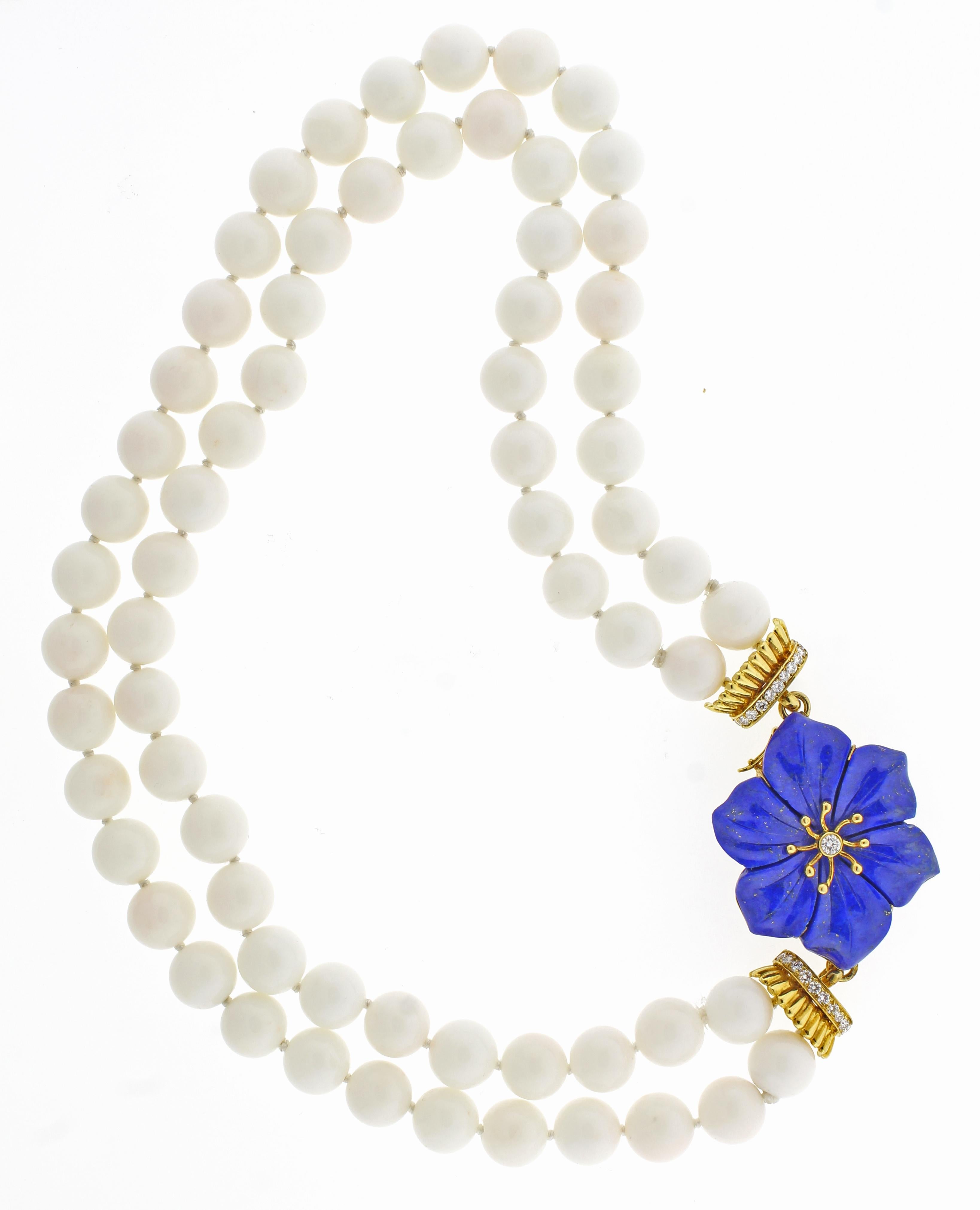 From Trio an 18 karat lapis and white coral 17 inch necklace.  The coral beads measure  10.5mm with  23 Diamonds weighing .70 carats, 17 inches overall 