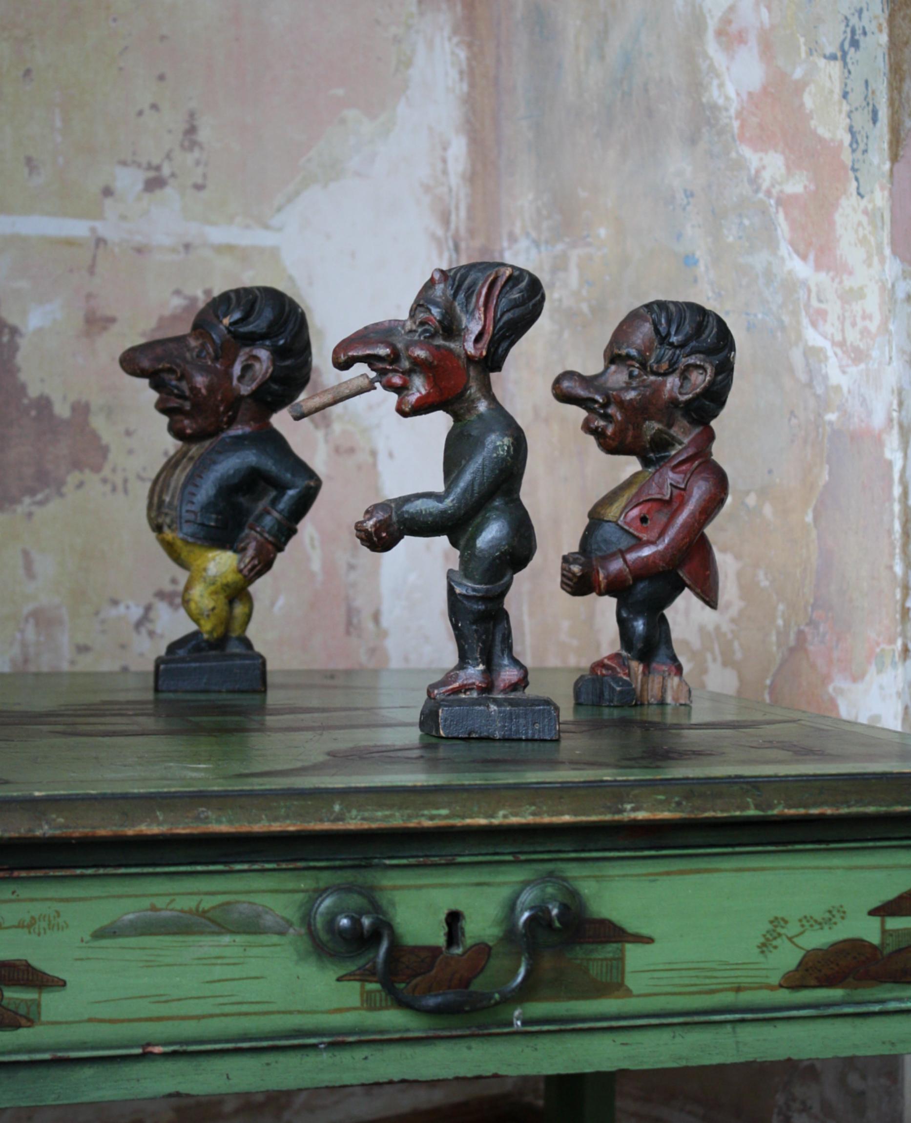 A whimsical trio of hand carved Jeu de Massacre fairground figures, each figure is artfully carved in pitch pine and hand coloured.

Areas of minor wear, some abrasions, knocks, to the original paintwork. A small section of the base is missing