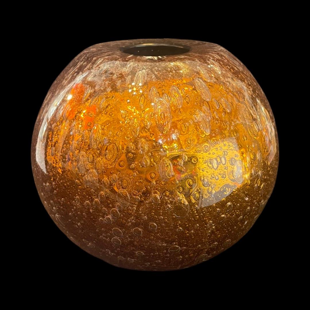 Introducing a set of three hand-blown glass spheres designed by Alberto Dona, these captivating pieces are perfect additions to elevate your home decor.
 
Crafted in Italy, each sphere is hollowed and features a stunning golden amber hue. The outer