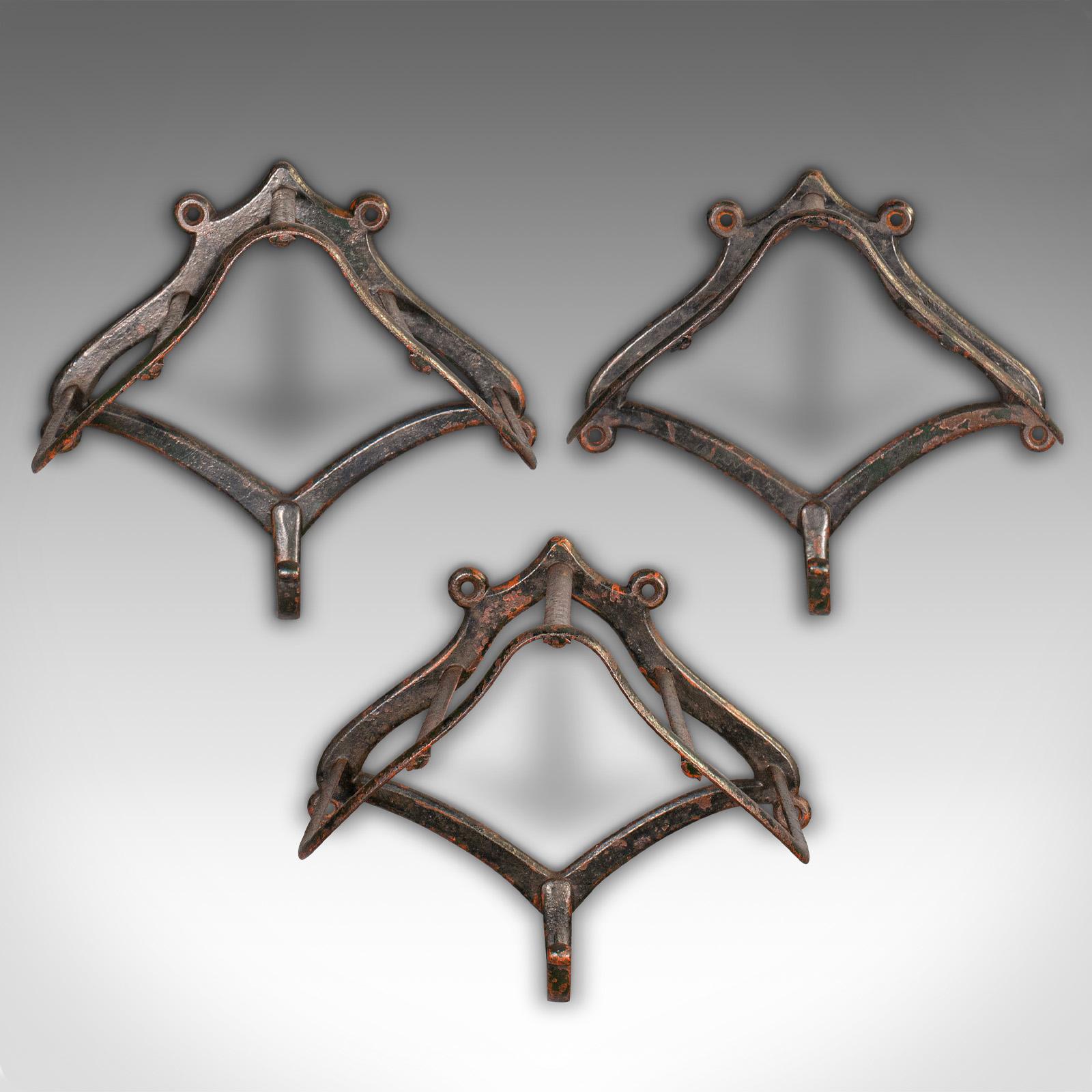 This is a trio of antique equestrian tack racks. An English, wrought iron wall mounted saddle rack, dating to the late Victorian period, circa 1900.

Pleasingly weathered and patinated antique racks, ideal for equestrian or display use
Displaying