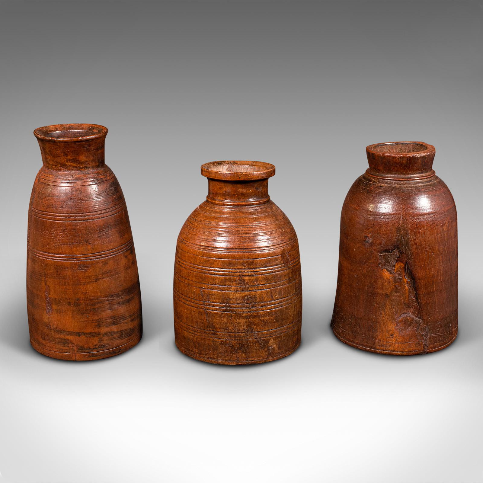 This is a trio of antique tribal vases. An Indian, hardwood accent jar or urn with rustic taste, dating to the late Victorian period, circa 1900.

Fascinating hand finished appeal to this trio of tribal accent pieces
Displaying a desirable aged