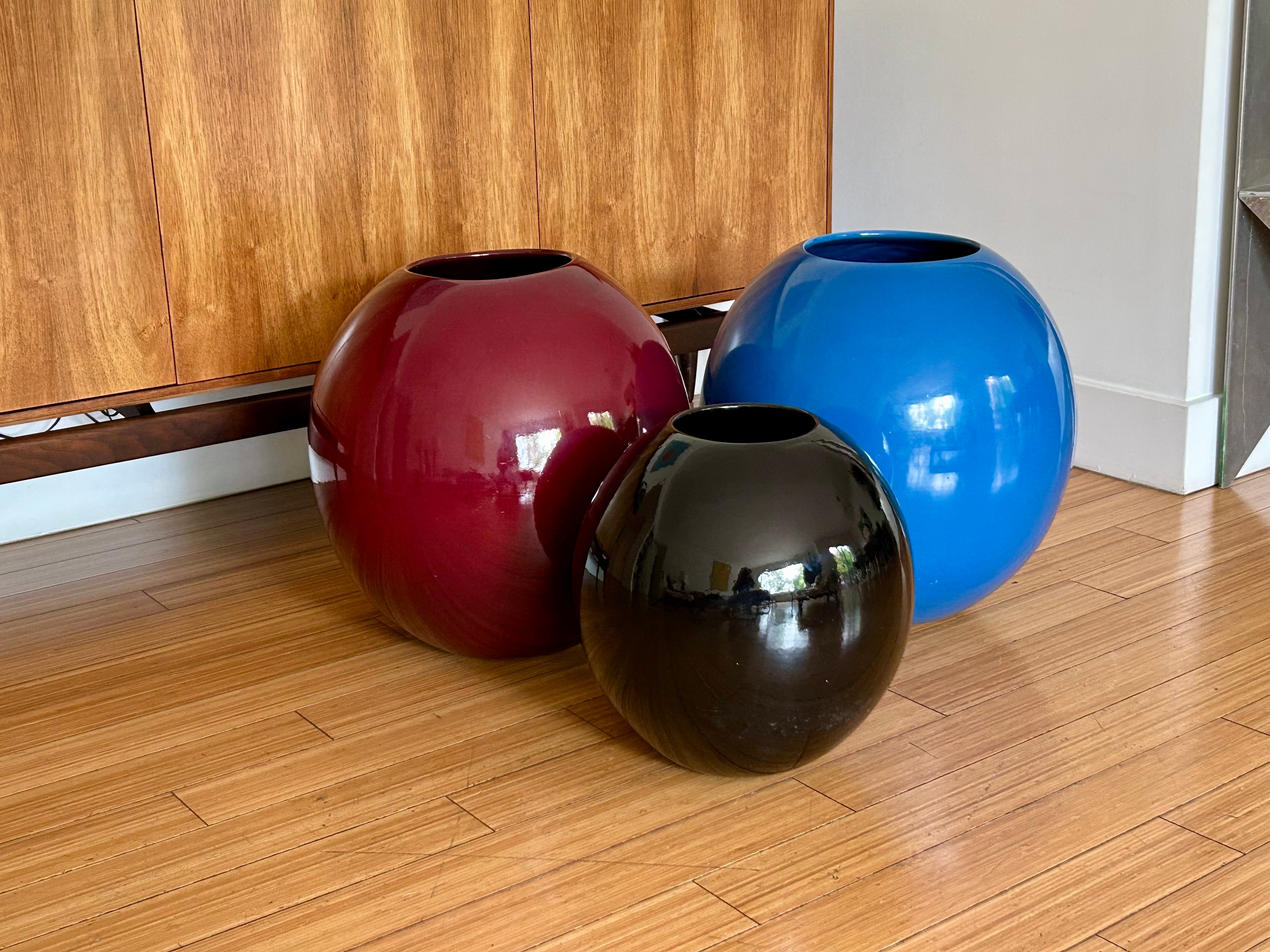 Great set of California design planters.
Spherical forms in candy gloss hues of black, wine and azure.
No drain holes.
Great for indoors.
Minute scuffs and patina.
No chips, cracks or repairs.
Ring sound when knocked. 
Great for decor and