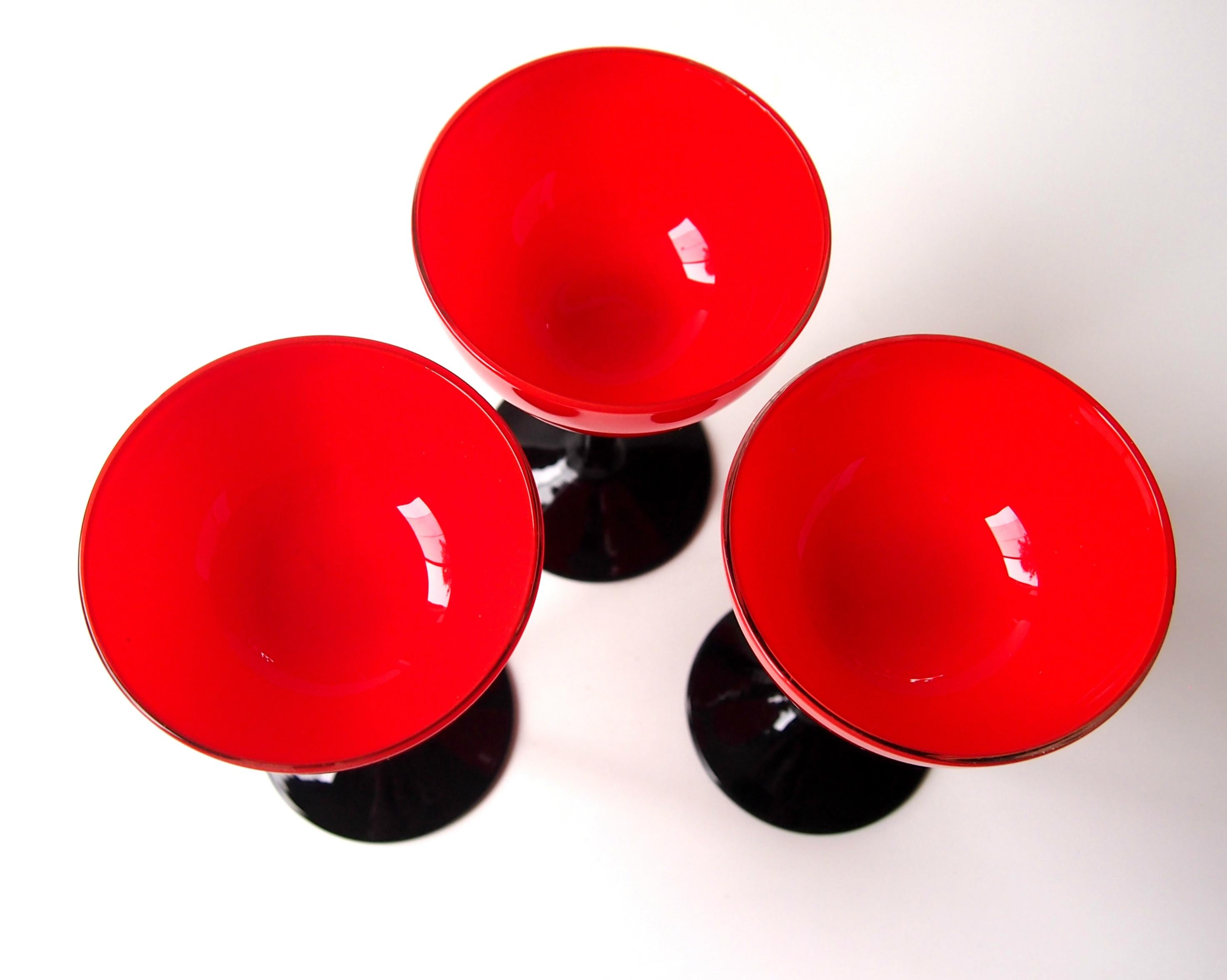 Dramatic Trio of 'Tango' Art Deco Harrach wine glasses in vibrant red on black stems. Bohemian Tango ware was very popular in the USA in the 1920s and 30s and it was made by many companies. There are most likely Harrach but it is not always possible