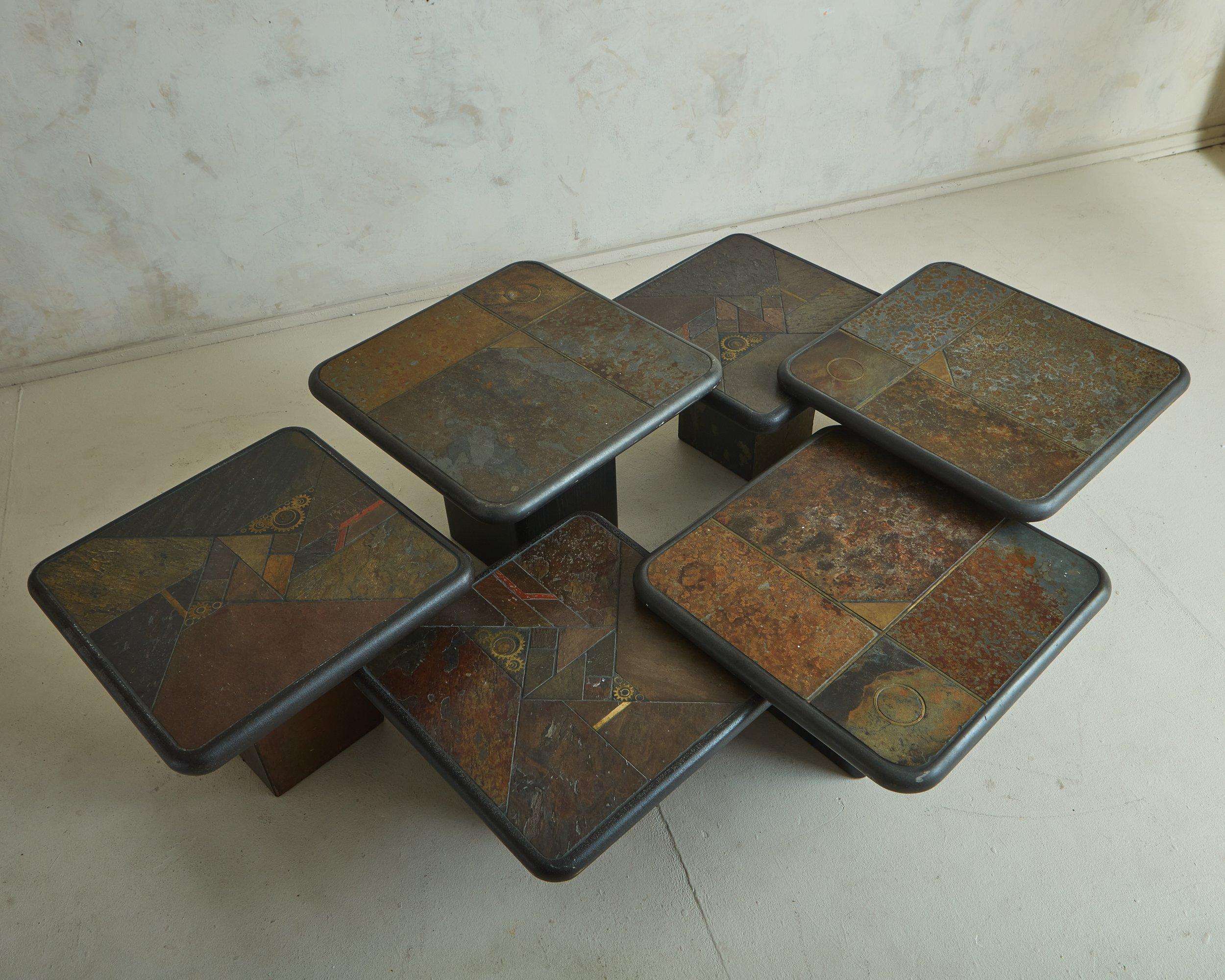 A trio of nesting mosaic tables designed by Dutch Sculptor, Paul Kingma and produced by Kneip in 1998. The table tops feature a mosaic of inlaid metal finishes, artfully crafted, with rounded edges and rest on wood bases. (The second set available