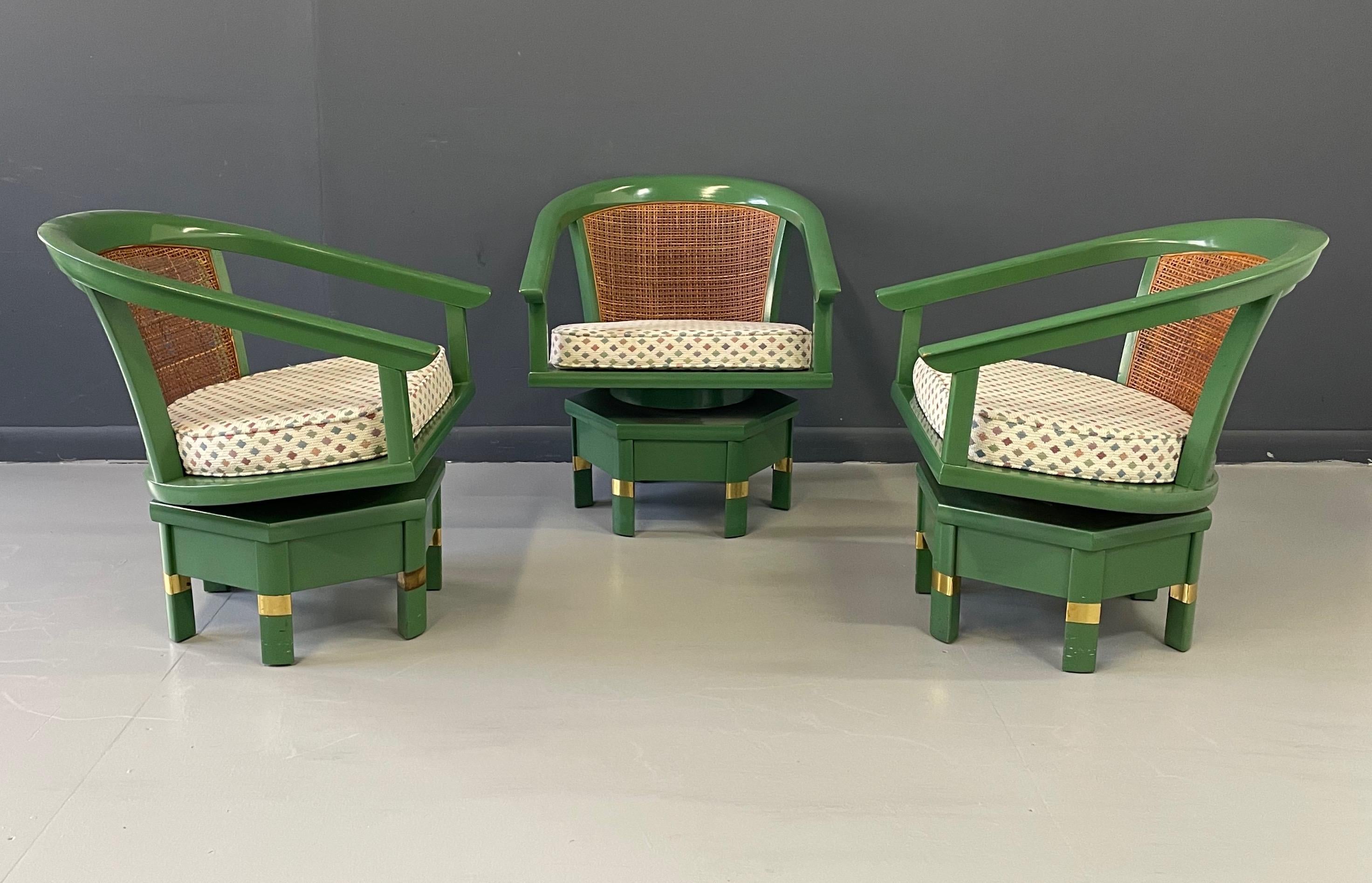 Oft attributed to Edward Wormley and Dunbar, these chairs are actually model 5105 designed by Jim Peed for Hickory Manufacturing. These striking chairs have a barrel back with caning and sit on a hexagonal swivel base. There is brass trim to the