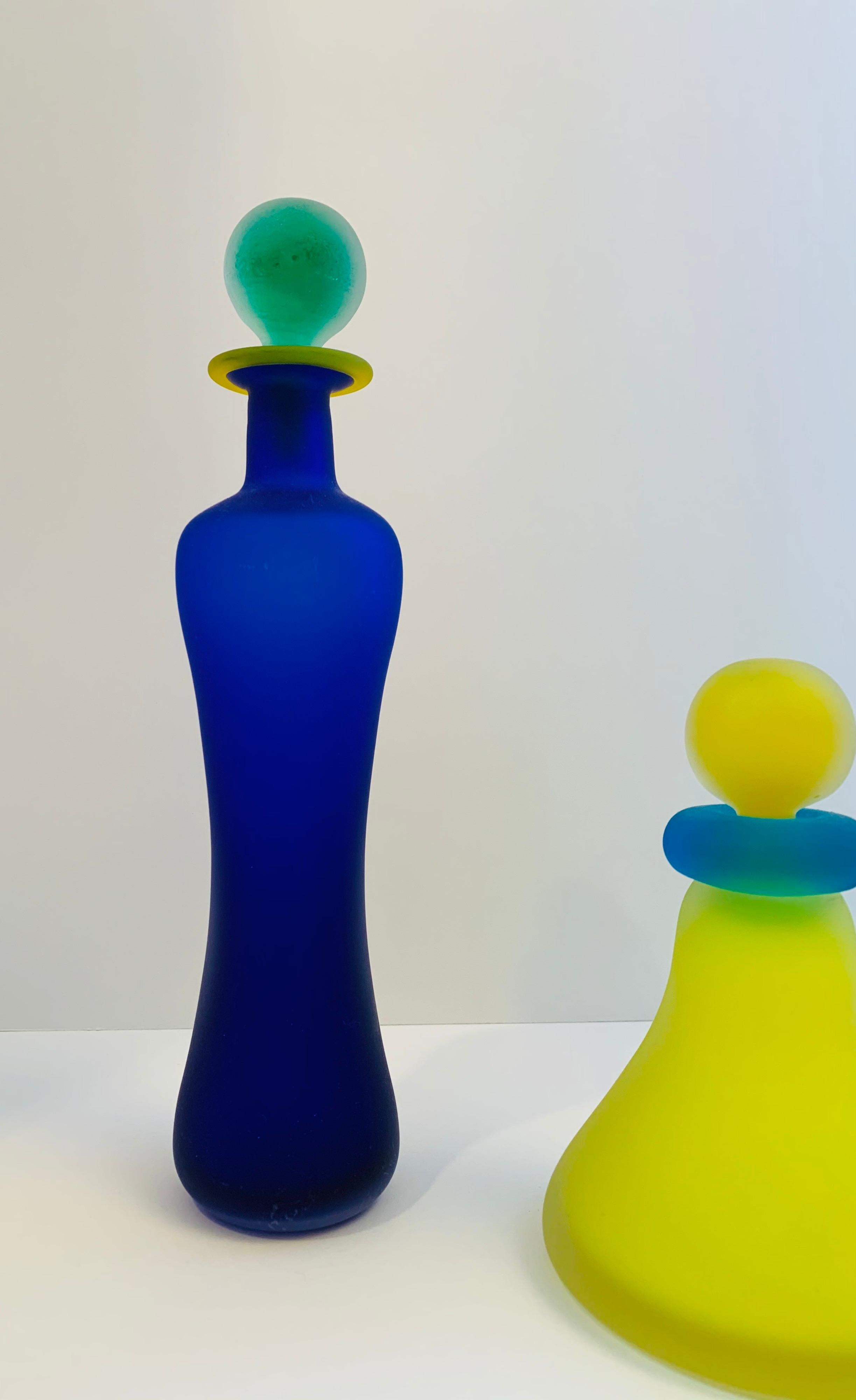 A playful yet precious trio of Italian Art Glass perfume bottles.

These modernist beauties are done in vivid colors with a soft sanded 