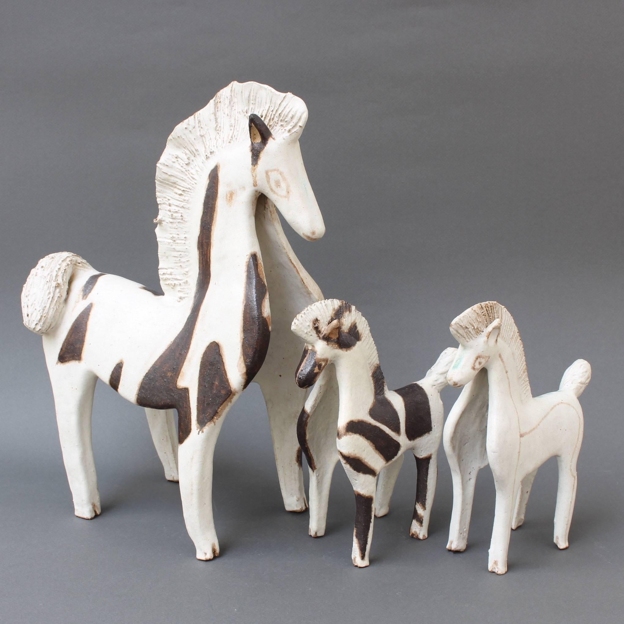 Trio of ceramic horses by Bruno Gambone, (circa 1970s). Wild, free and powerful, these three ceramic horses were created in Gambone's signature chalk-white glaze with dark brown markings on two of them. They are very elegant and charming, and very