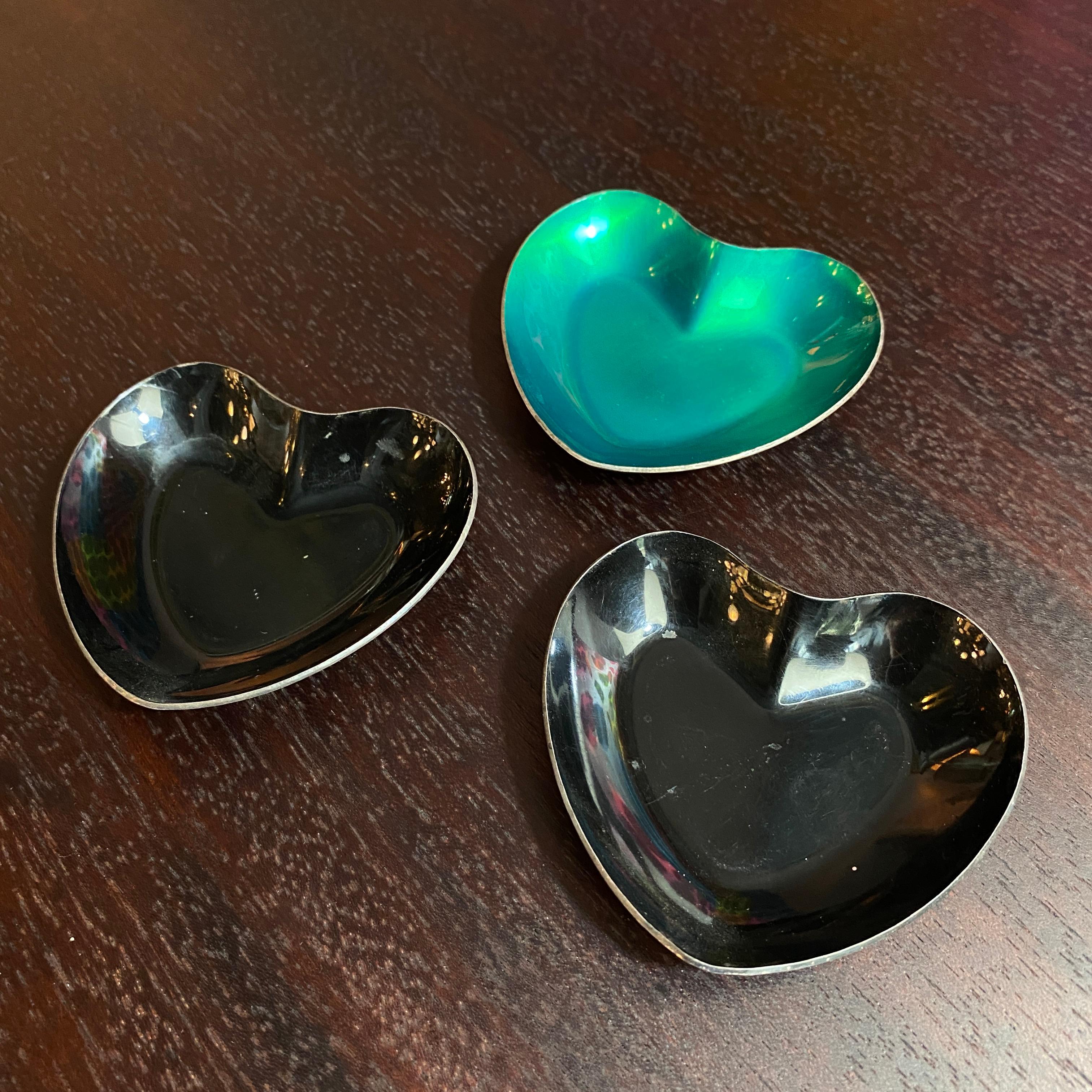 Trio of petite Danish modern, colored enamel, sterling silver, heart-shaped stacking dishes in shimmering green and glossy black. Marked Meka Denmark on the back. This colorful set works as serving dishes, pin trays or ring holders. 