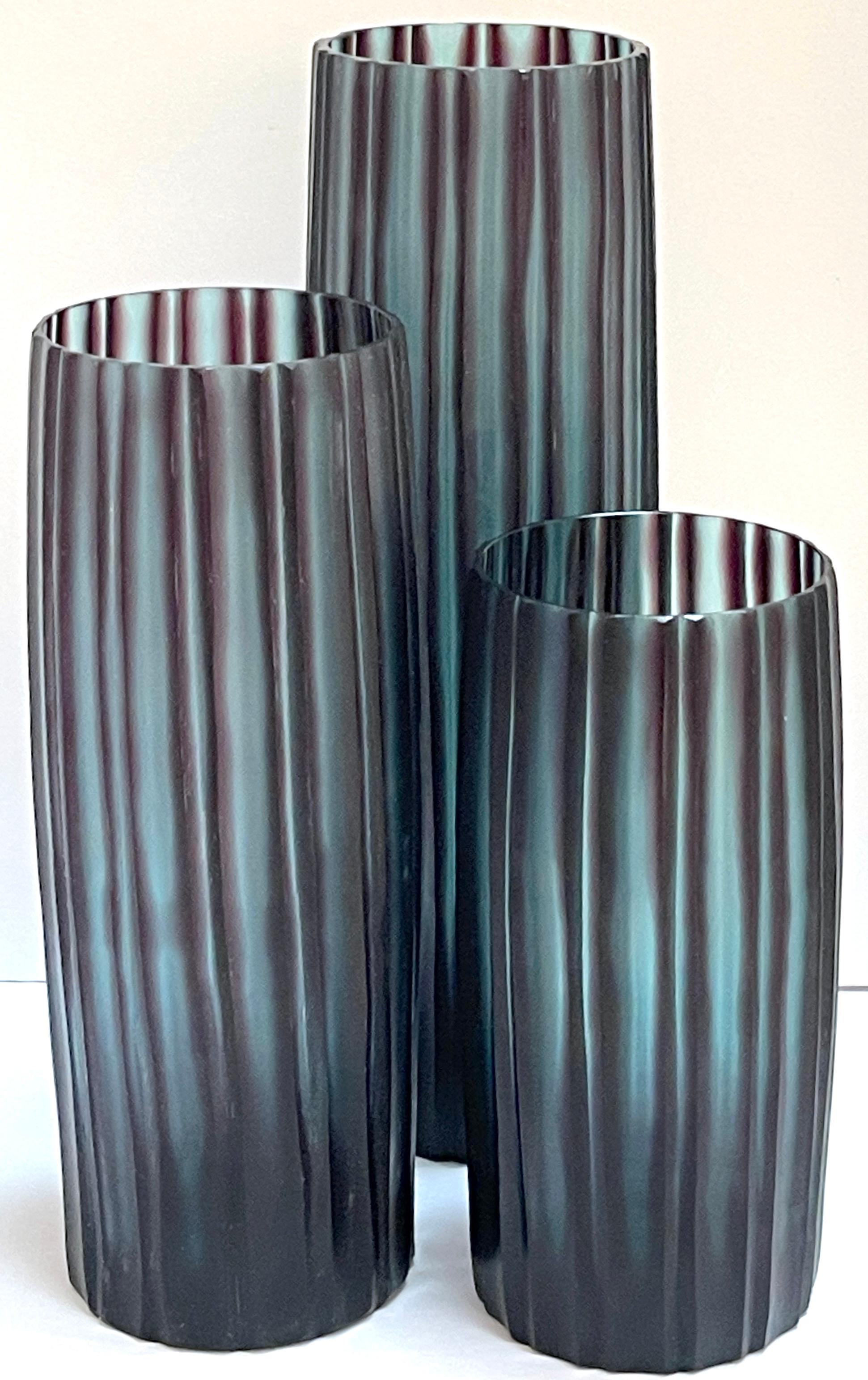 Trio of Donghia Carved Murano Glass 'Bamboo' Vases
Italy, circa 1990s 

A trio of exquisite Donghia-carved Murano glass 'Bamboo' vases from Italy in the 1990s. This stunning ensemble comprises three elegantly crafted vases, each depicting a modern
