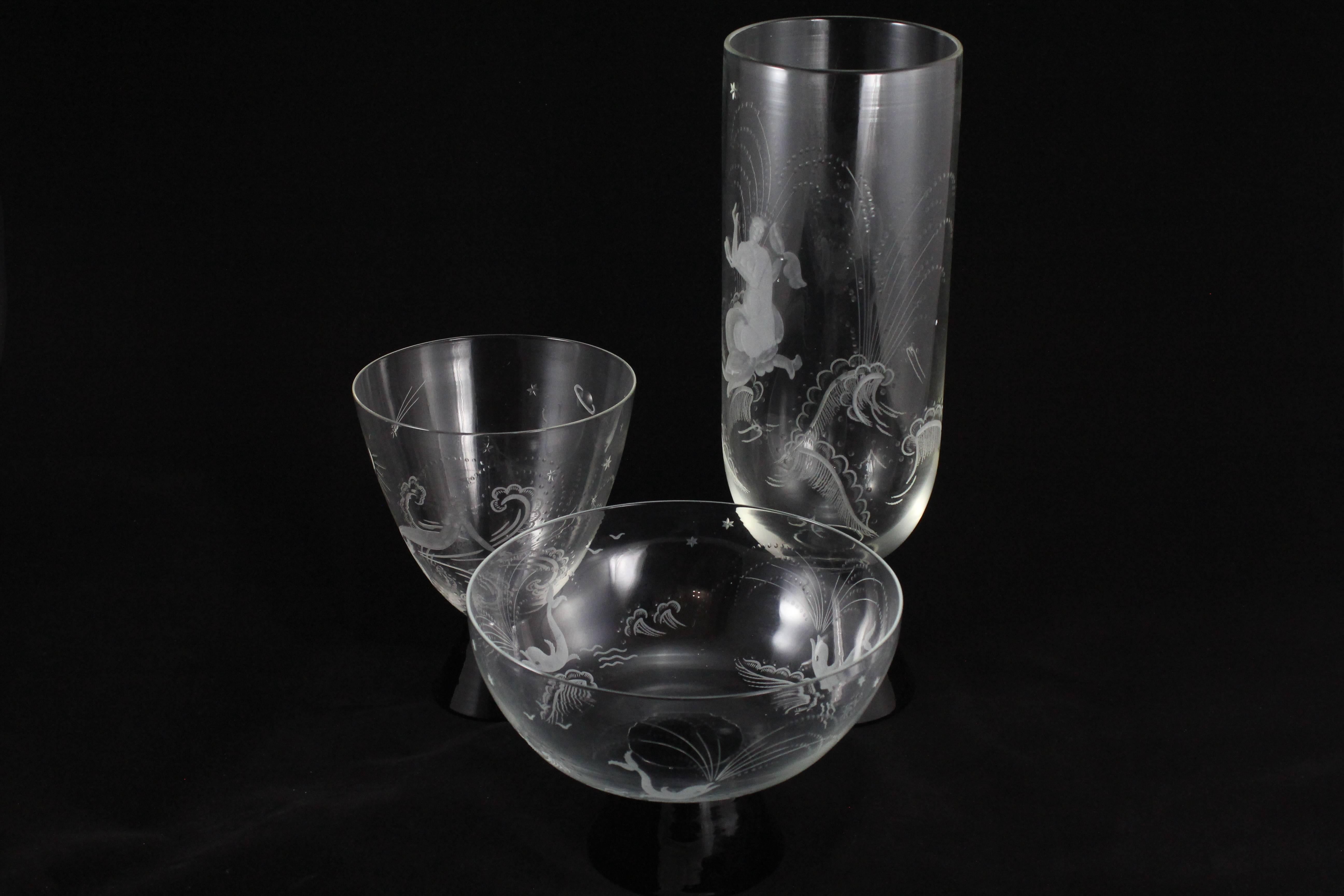 A very fine example of the work by Venetian glass artisan Guido Balsamo Stella. This trio of meticulously hand etched glass vases, circa 1925, depict mermaids, dolphins and the galaxy on exceptionally fine, tiered vessels with conical black glass