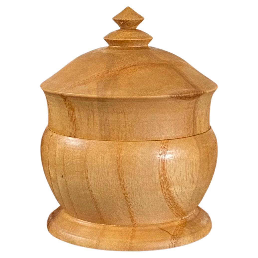 A collection of handmade, hand-turned, exotic hardwood follies. These tiny sculptural boxes are true beauty. They will add a Minimalist flair to any spot you select for them, whether that is a bookshelf, coffee table, or in a gift box for one of
