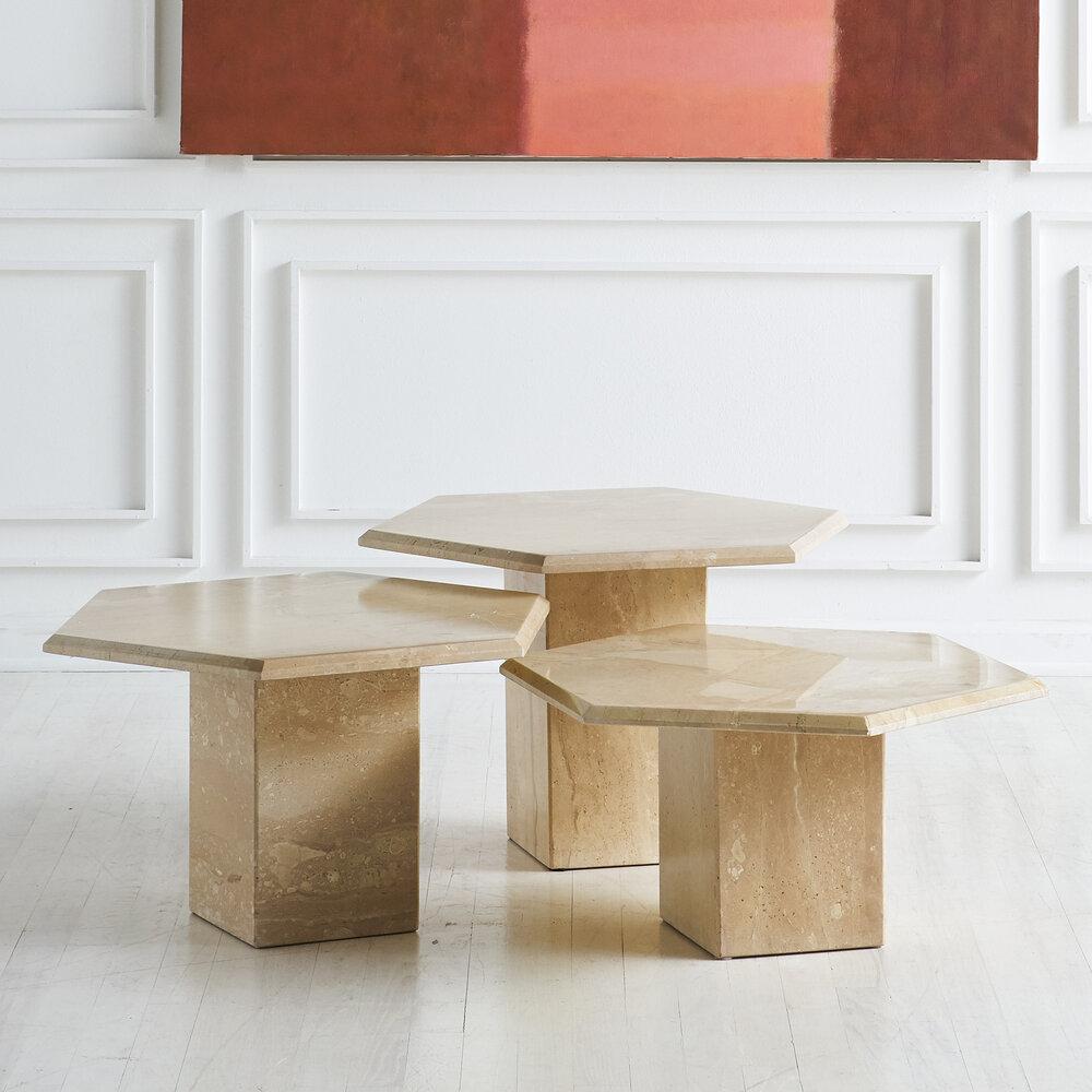 A trio of polished Travertine coffee tables with hexagon table tops and a square travertine base. A wonderful combination with a variety of options for use. Sourced in France, 1970s.

Dimensions: 16