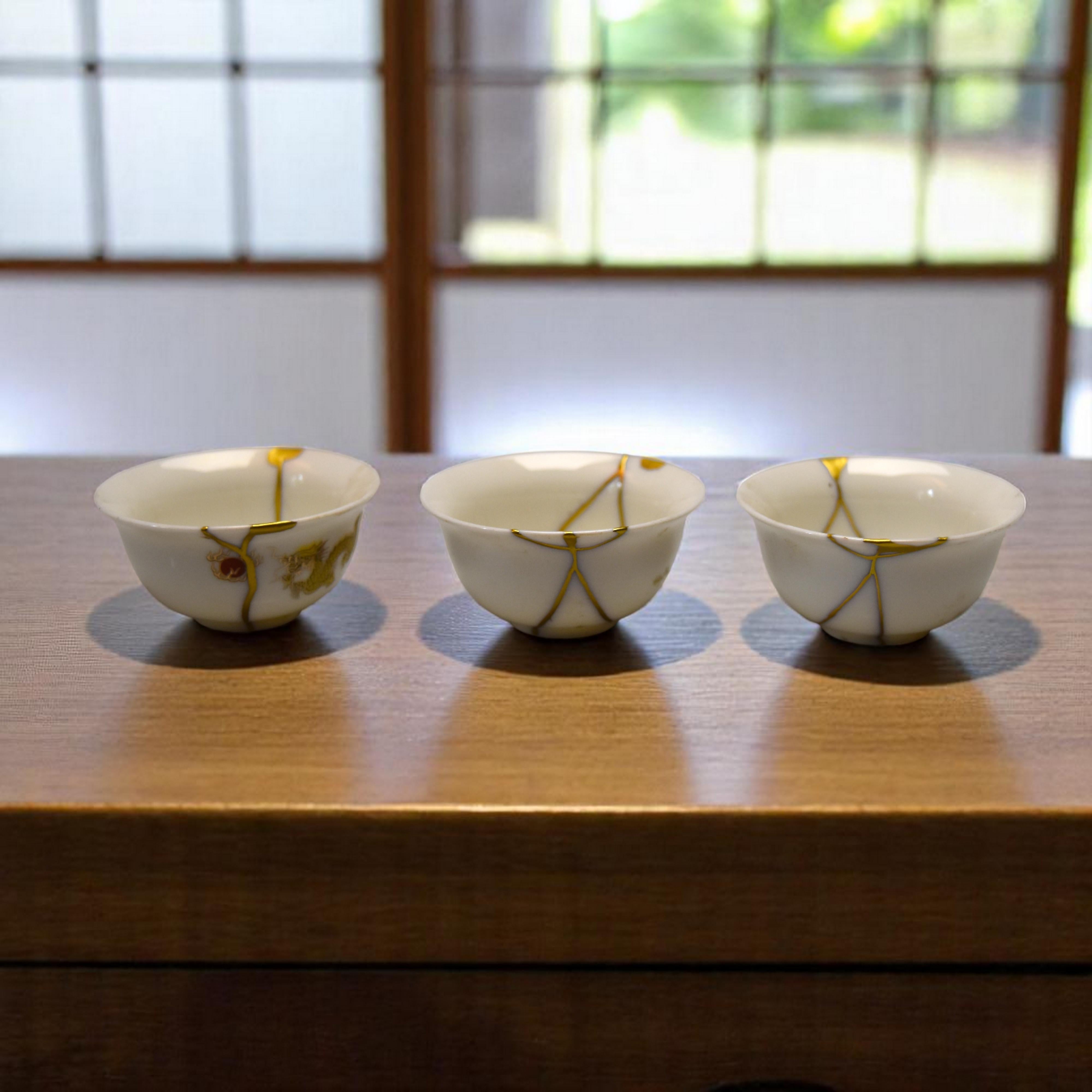 The Dragon’s Breath: Trio of Kintsugi Sake Cups, an Odyssey of Gold and Porcelain

Imagine the powerful, majestic breath of a mythical dragon swirling around the purest porcelain. It’s this very strength, this same timeless elegance, that you’ll