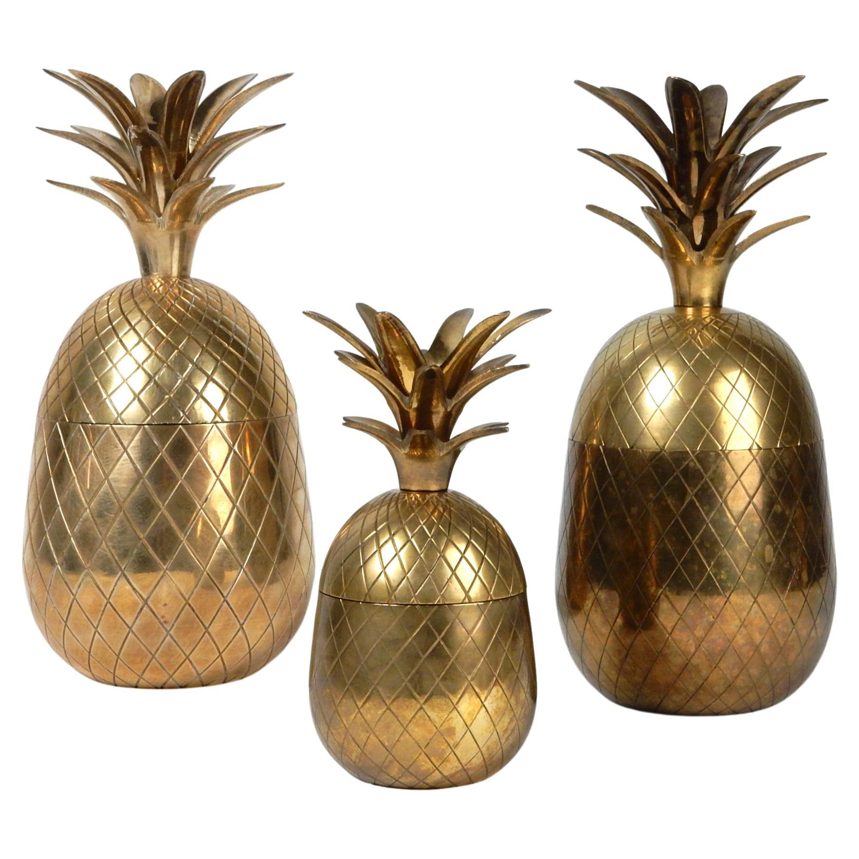 Perfect table centerpiece! 
A set of three vintage chiseled brass pineapple sculpture boxes.
Tallest is 12