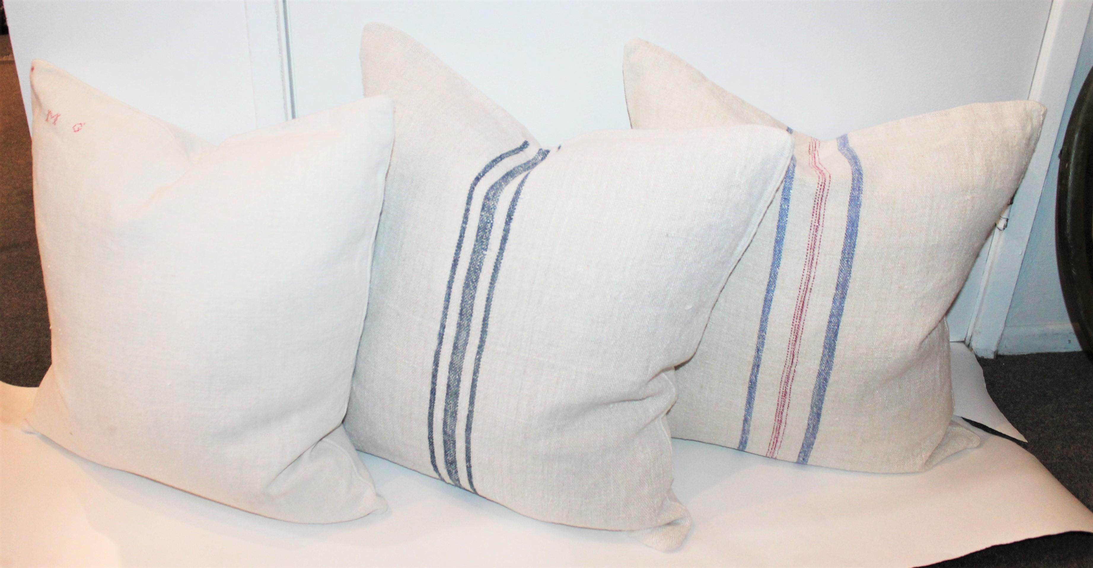 Hand selected 19th century linen made into a set of three pillows. This linen has been professionally laundered/cleaned and made with the best vintage linens found.

The blue and red striped linen pillow is a double sided with identical pattern on