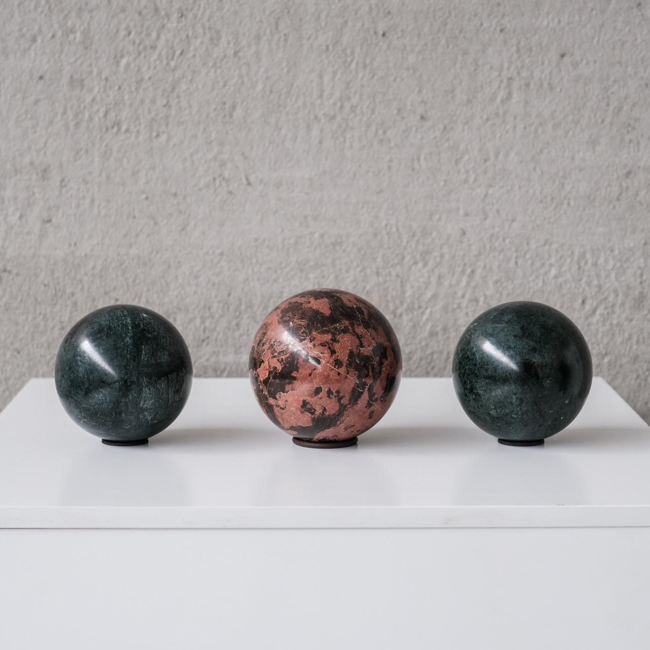 A set of three marble specimens. 

Belgium, circa 1970s. 

Formed in spheres. 

Two green specimens - 8.5 diameter, a slightly larger sphere at 10 diameter in cm. 

Price is for the set of three. 

Location: Belgium Gallery. 

Dimensions: 10