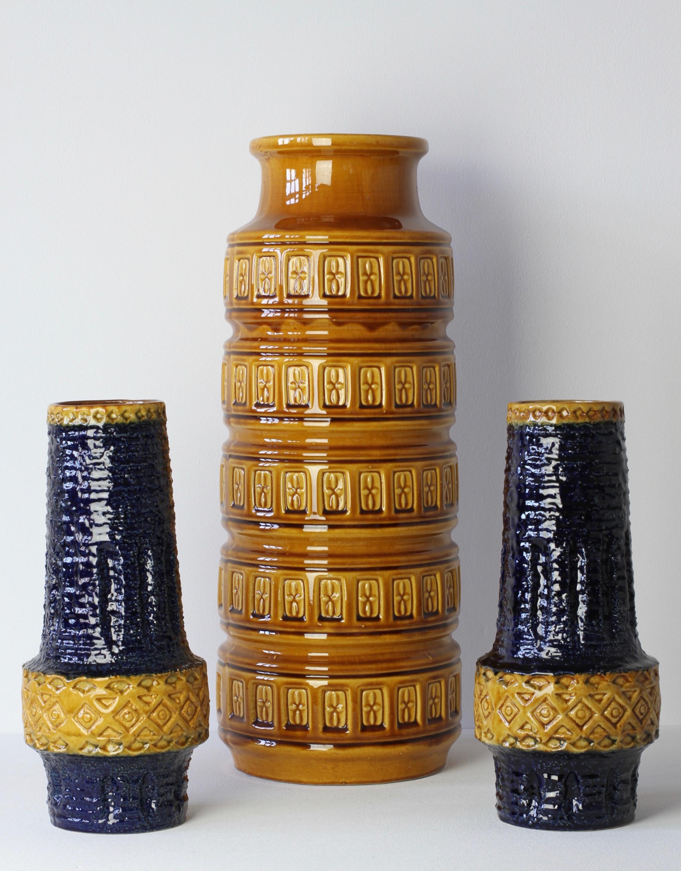 Trio of tall vintage midcentury vases by West German Pottery producers - 'Bay Keramik' and 'Spara', Germany, circa 1970s. The embossed relief pattern on the pair of Spara vases is not dissimilar to the style of Italian pottery designer Aldo Londi