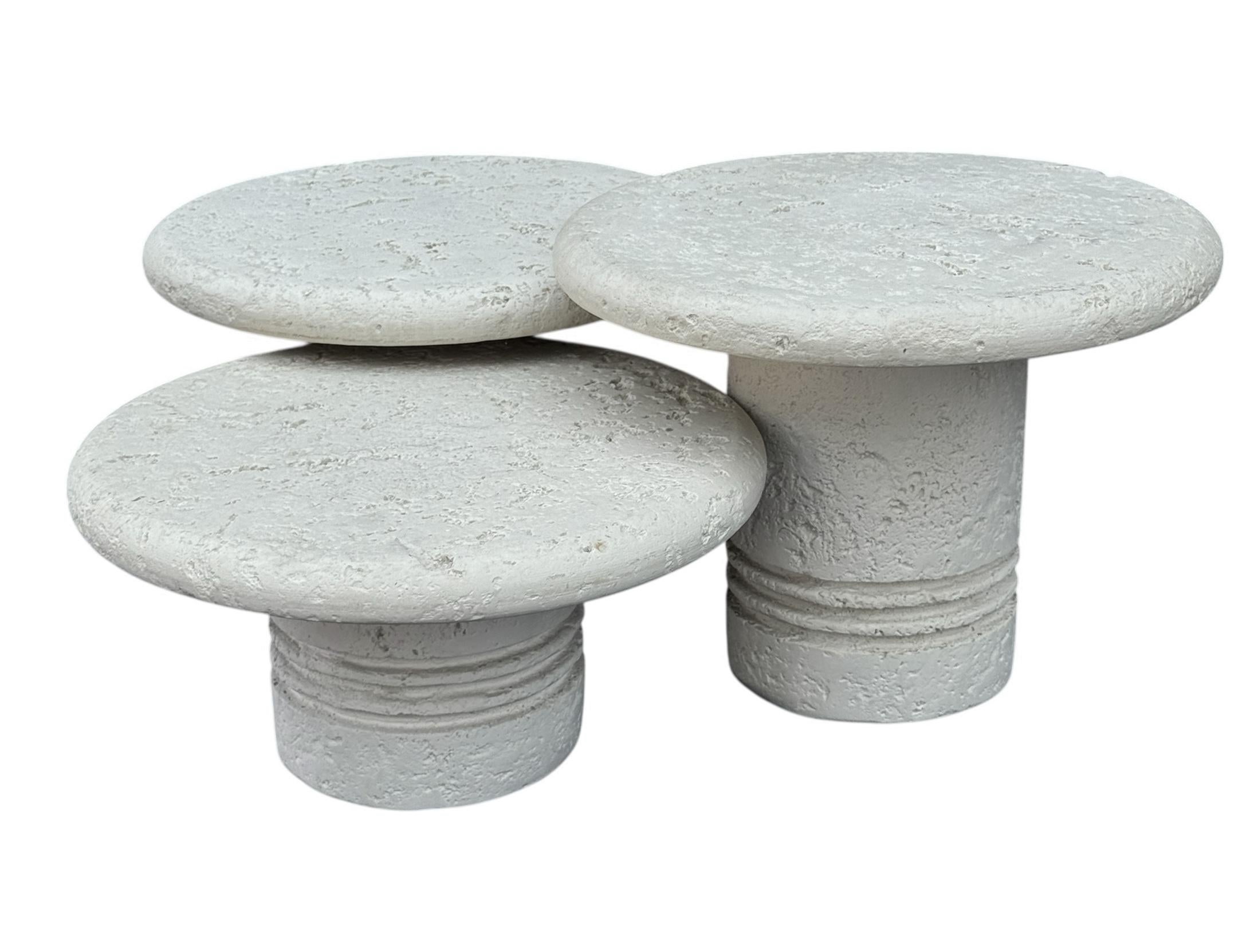 A post modern set of three circular cocktail tables from Italy circa 1980's. Each table measure 21 inches in diameter. The heights are graduated from 16.5, 14.5 & 11.5 inches tall. Heavy plaster resin construction. All in very good condition. 