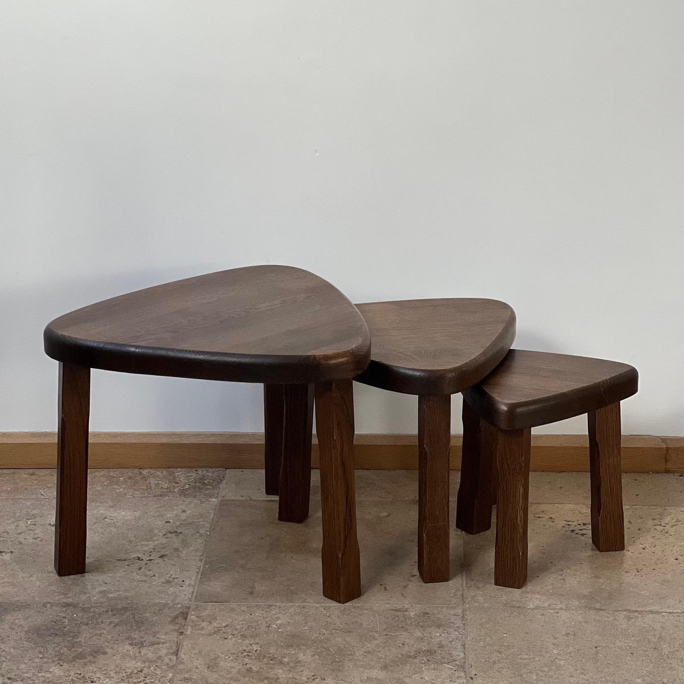 A set of solid blonde oak nesting tables. 

Echoes of Chapo's T23 table shape. 

France, c1970s. 

Useful, stylish and functional. 

Can be used in a nest, or set around the room as side tables. 

Dimensions for the largest table.