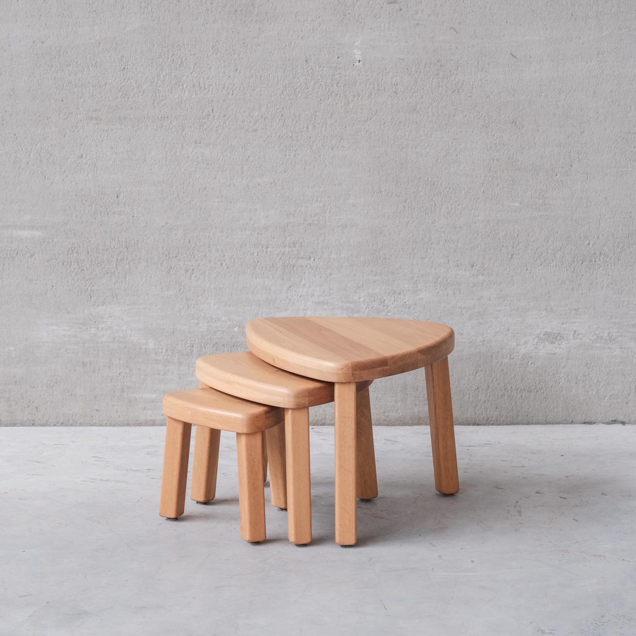 A set of solid blonde oak nesting tables. 

Echoes of Chapo's T23 table shape. 

France, c1970s. 

Useful, stylish and functional. 

Can be used in a nest, or set around the room as side tables. 

Dimensions for the largest table. 

Internal