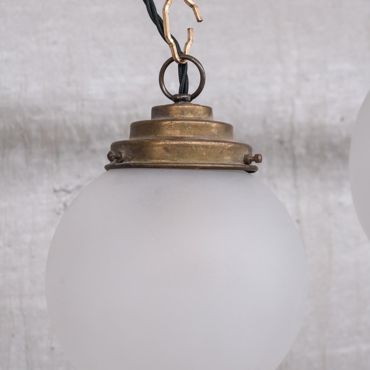 French Trio of Opaque Glass and Brass Pendant Lights For Sale