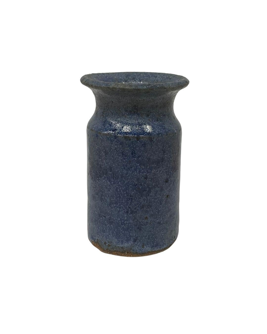 Set of three blue speckle-glazed miniature pottery vases. The variegated matte glaze on these vintage pieces imparts the color of a well-worn pair of denim jeans. 

Dimensions: Each vase measures approximately 3.25