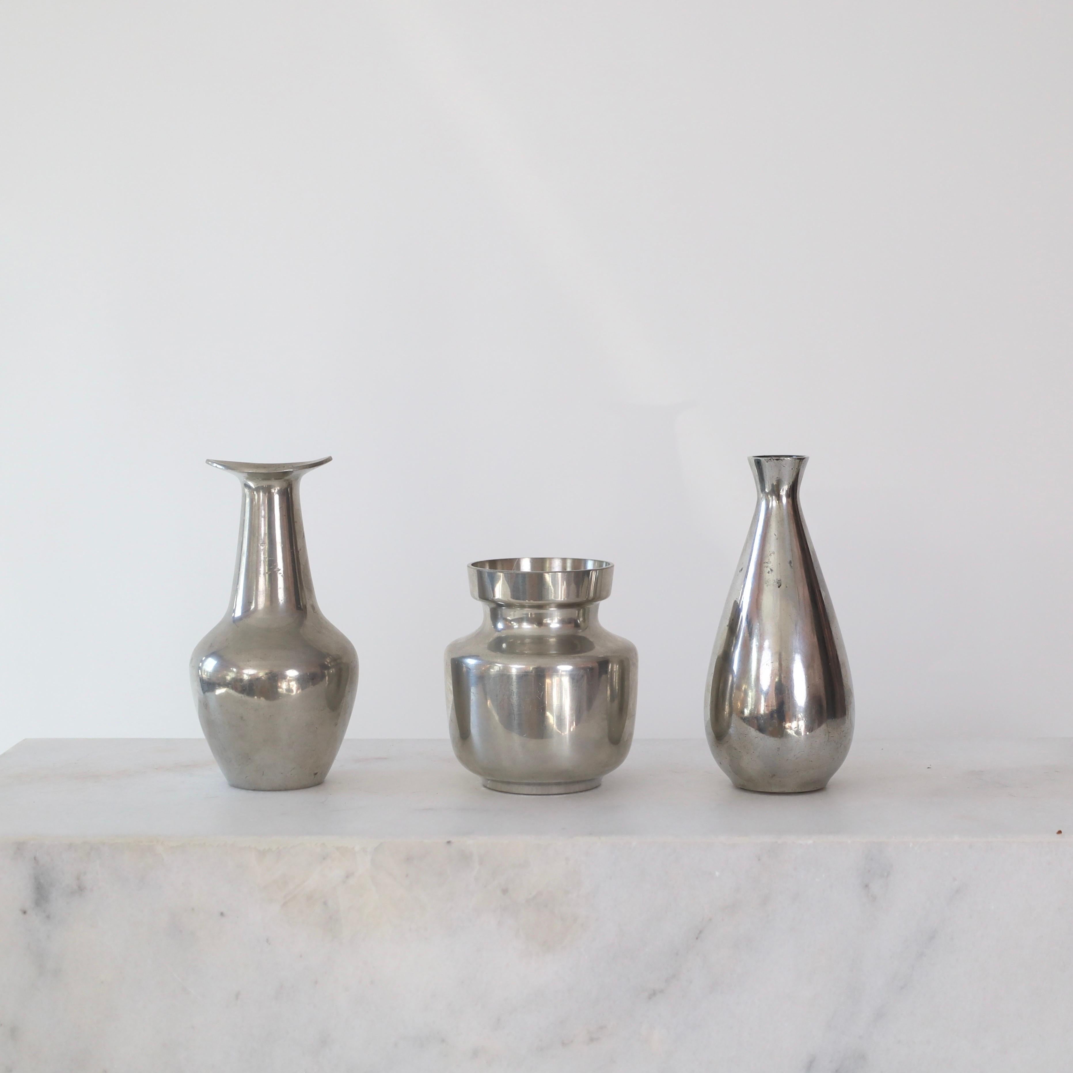 Set of three pewter vases made by Just Andersen in the 1950s. A fine trio for a beautiful home.

* Set (3) different pewter vases - two bottle shaped and one round.
* Style: 2721, 2727 and 2762
* Manufacturer: Just Andersen
* Year: 1950s
*