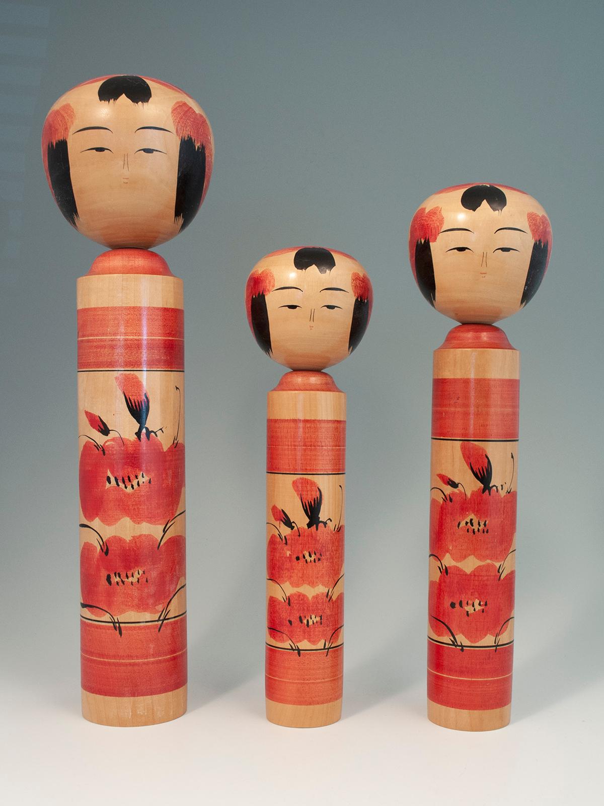 Trio of Traditional Kokeshi Dolls by Masahiro Satomi (1948-1994), Japan

Three traditional kokeshi dolls created and signed by Masahiro Satomi (1948-1994). They measure 14.5, 12 and 10.5 inches high. In good condition, with some shellac loss on head