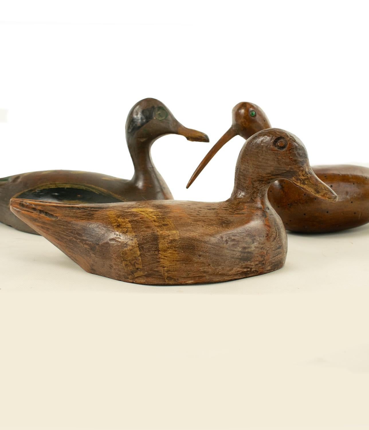 A trio of two Ducks and a Curlew - ancient decoys used for shooting. Naively carved and painted. The curlew with evidence of gun shot.

Hand carved and painted. Paint now faded but all to a lovely aged patina and showing the richness of the wood