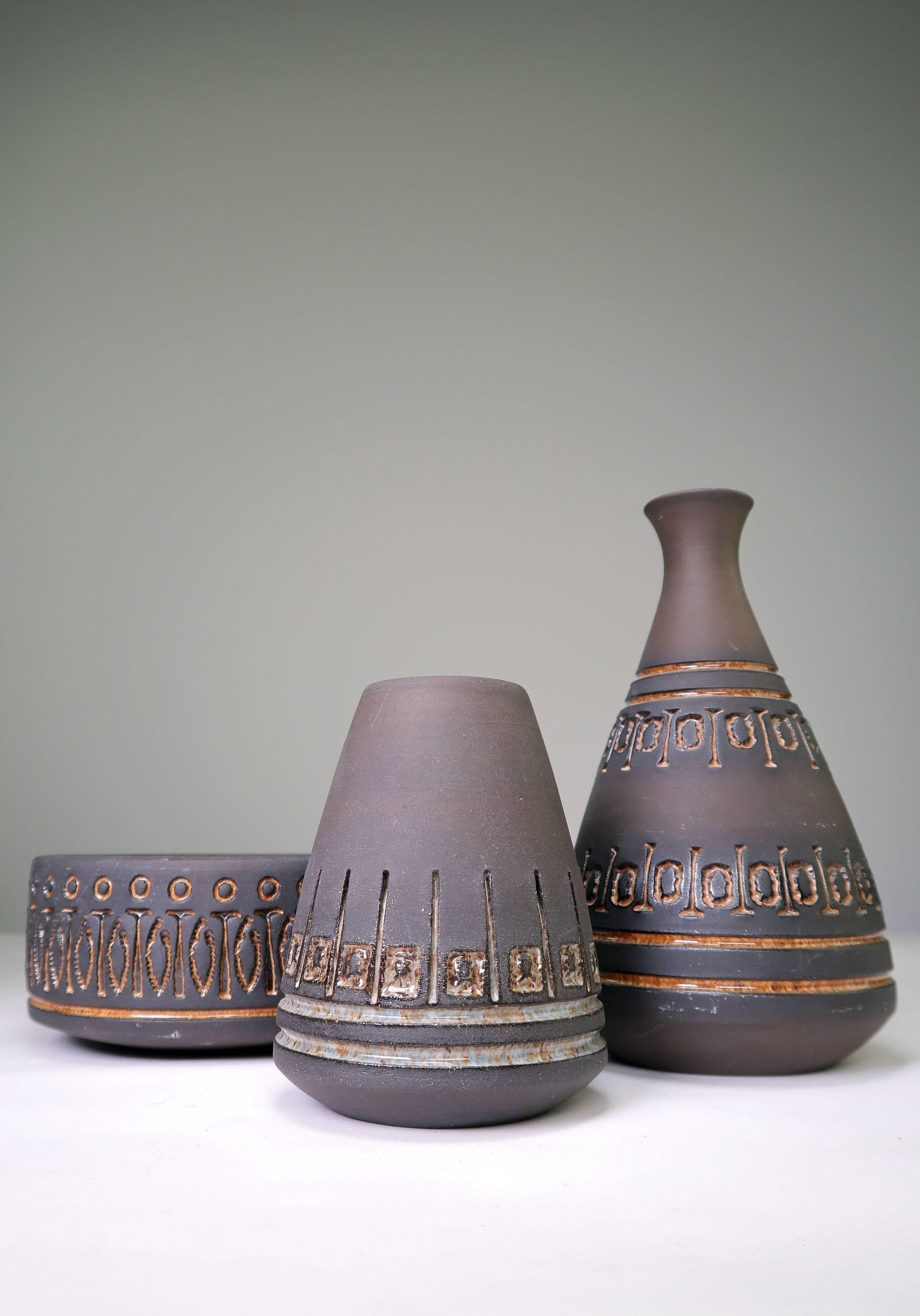 Set of three items. Two Mid Century Scandinavian Modern rustic vases and one bowl designed and manufactured by Swedish ceramic artist Ulla Winblad for Alingsås before she moved to Seattle in 1967. Manufactured in 1960s in the small town of Alingsås
