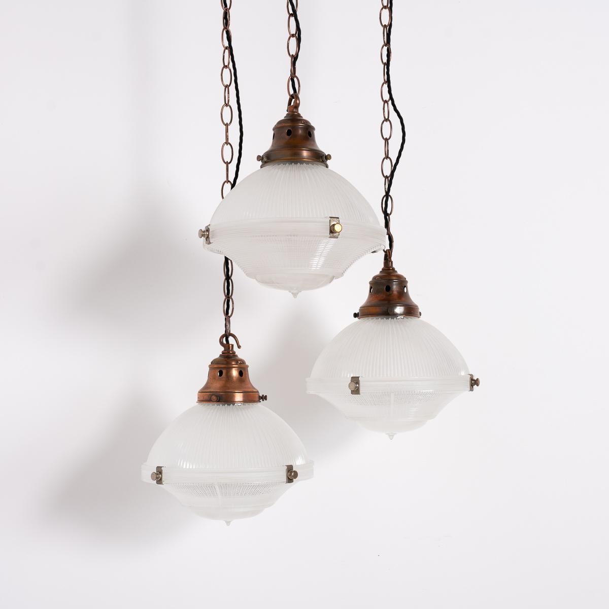 Holophane Reflector-Refractor Pendants with Coppered Galleries

Enhance your interior with this set of three vintage Holophane three-part pendant lights. Each light, complete and original, features Holophane’s 