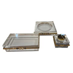 Trio of vintage lucite and brass, chrome banding desk accessories