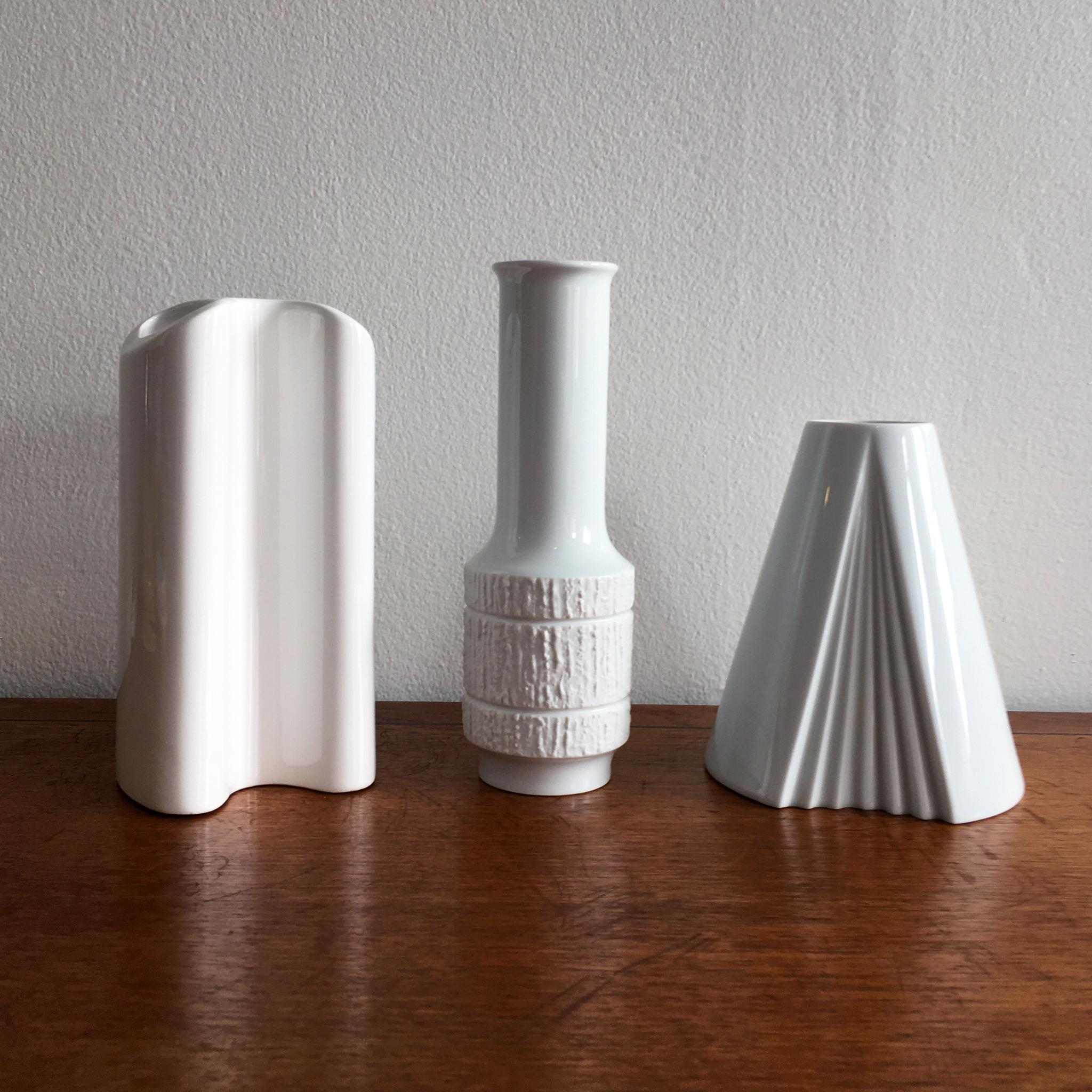 Trio of white vases including Thomas textured bisque detail vase by Richard Scharrer, Dansk curved design vase, Rosenthal Plissee vase by Ambrogio Pozzi. The shapes and textures of this trio beautifully complement each other. 

Measurements: