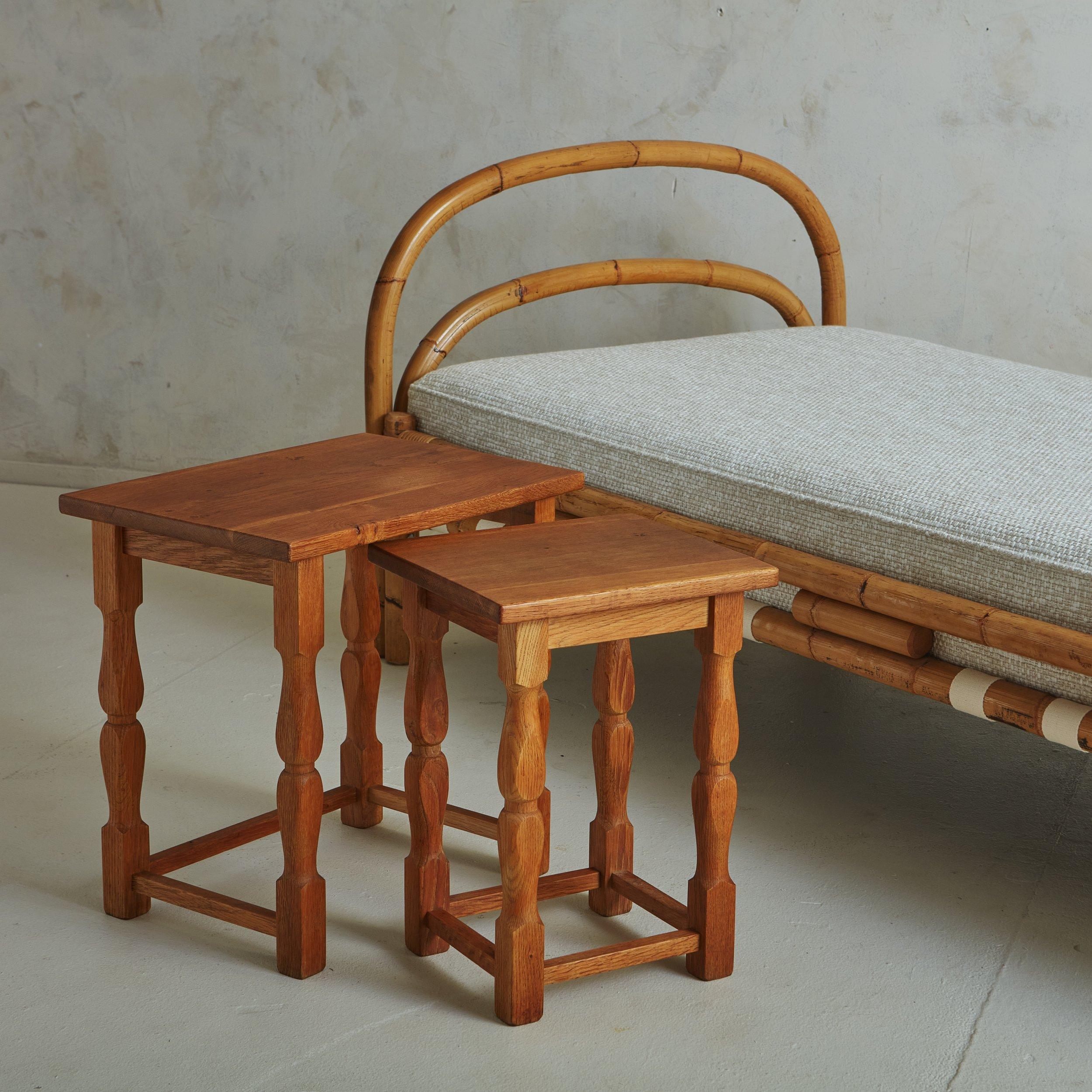 A trio of vintage wooden side tables sourced in Sweden. These tables have rectangular tabletops with spindle legs and lower stretcher details. They feature a beautiful wood grain and the versatile trio nests together, perfect for floating between