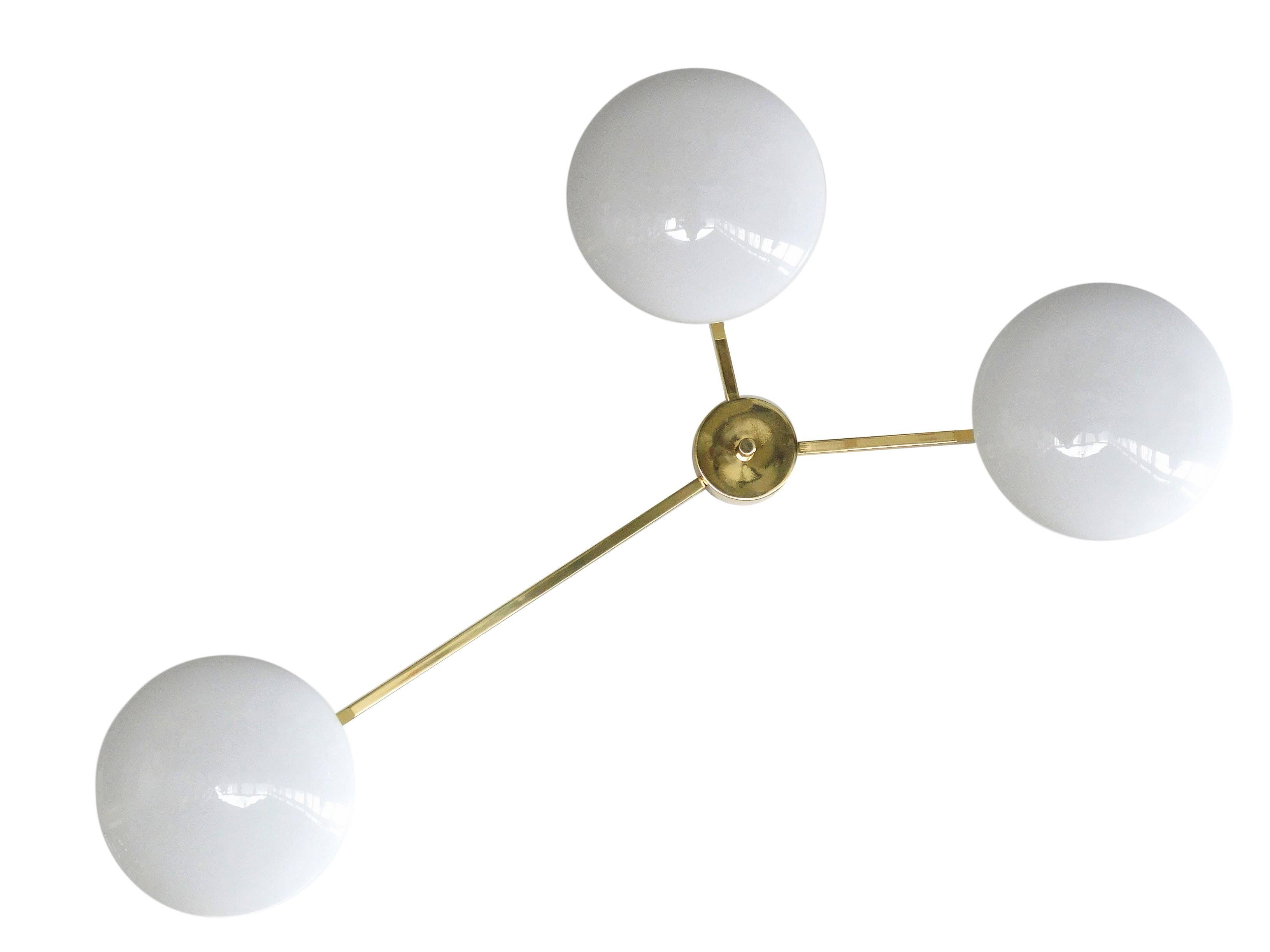 Italian midcentury flush mount with 3 glossy white Murano glass shades mounted on solid brass frame in polished brass frame / Made in Italy
3 lights / E12 or E14 type / max 40W each
Measures: Length: 53.5 inches / Width: 30.75 inches / Height: 7.5