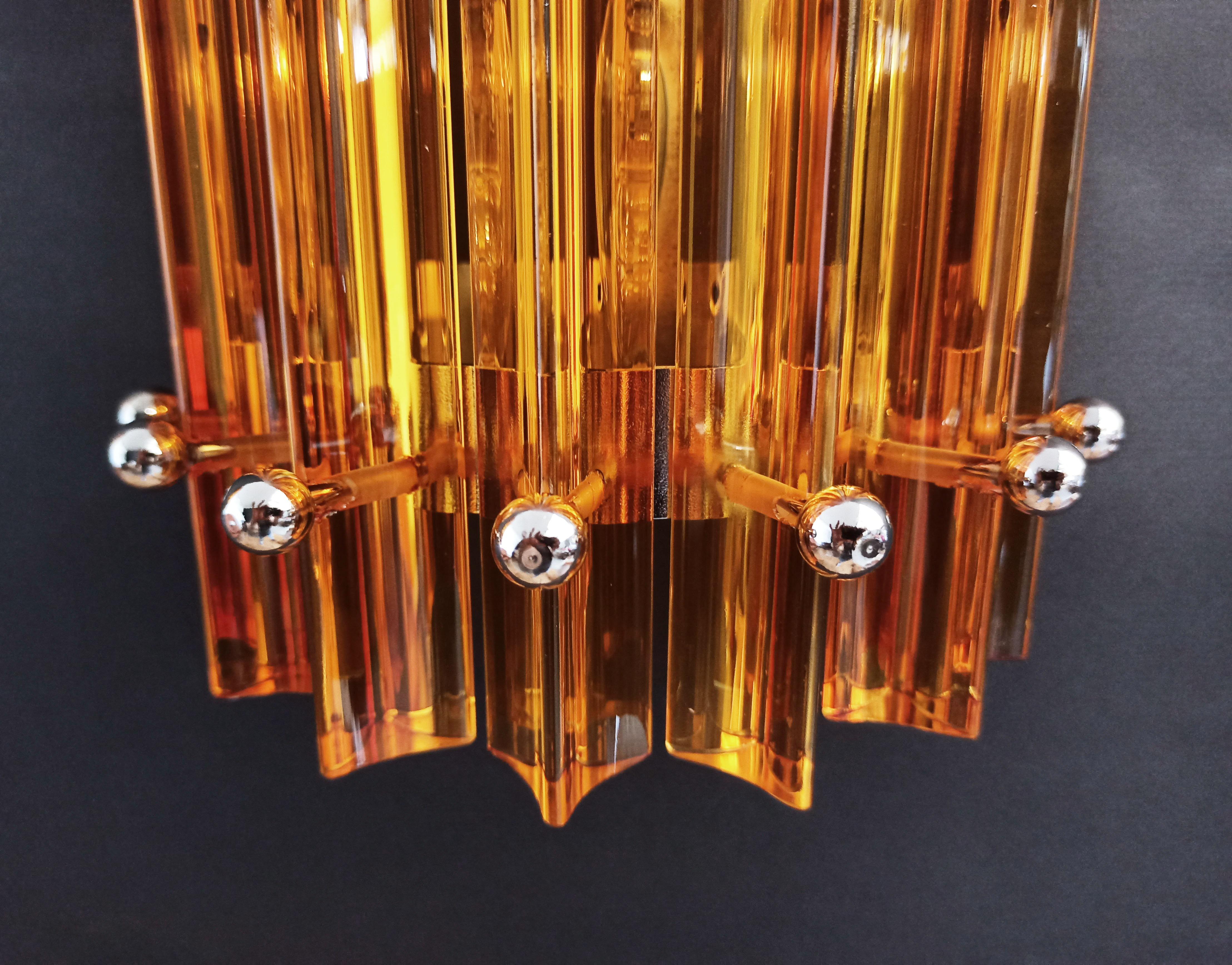 Trio vintage Murano wall sconce, amber triedri, column Mariangela model
Fantastic Trio of vintage Murano wall sconce made by 6 Murano crystal prism (triedri) for each appliqué in a chrome metal frame. The shape of this sconce is column. The glasses