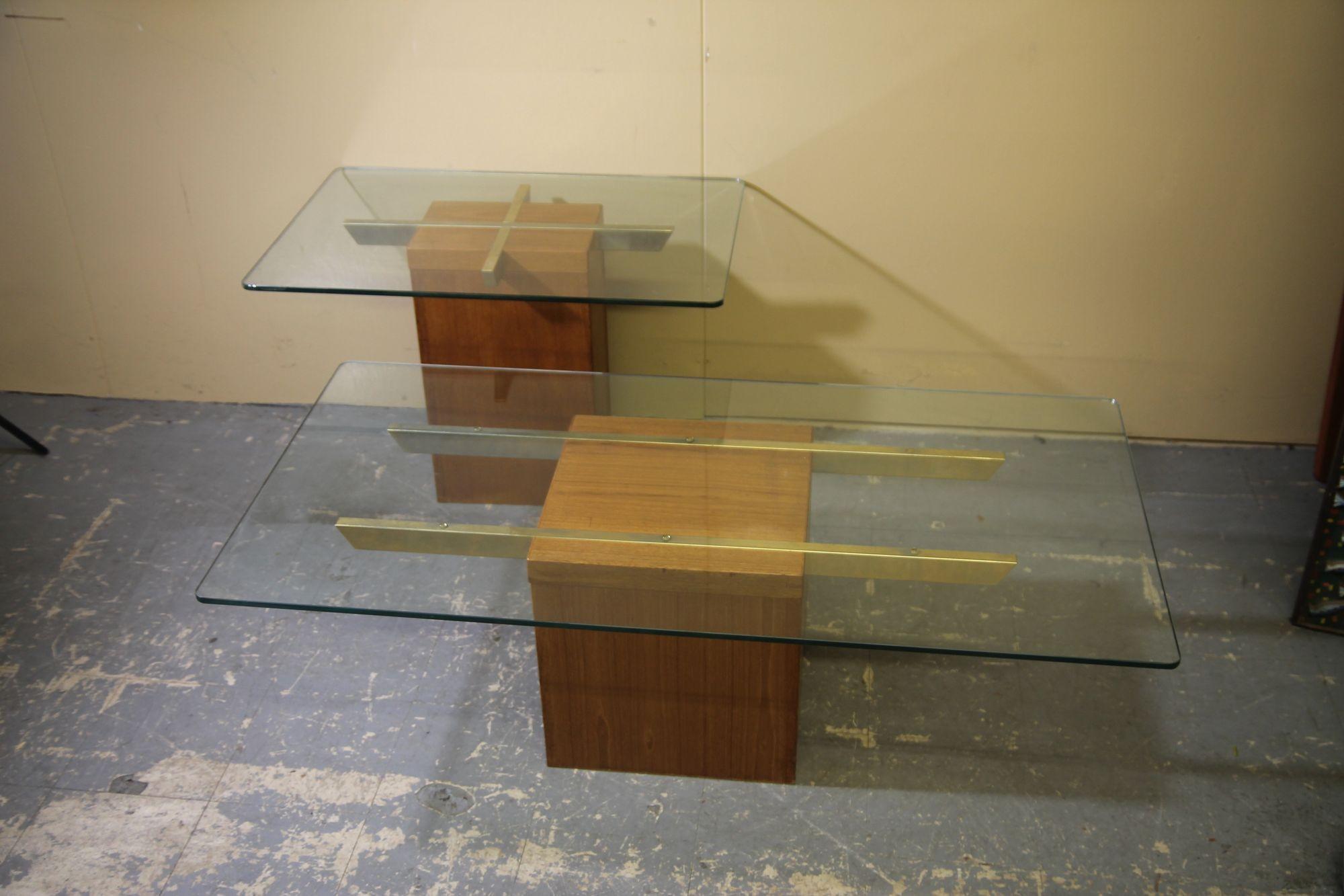 Coffee Table and Side table by the Danish Company Trioh Mobler. These pieces seldom come up for sale. These teak and brass base tables each have a glass top. The 1970's set is in nice vintage condition. Coffee table is 47x 23.5 x 15, Side table is