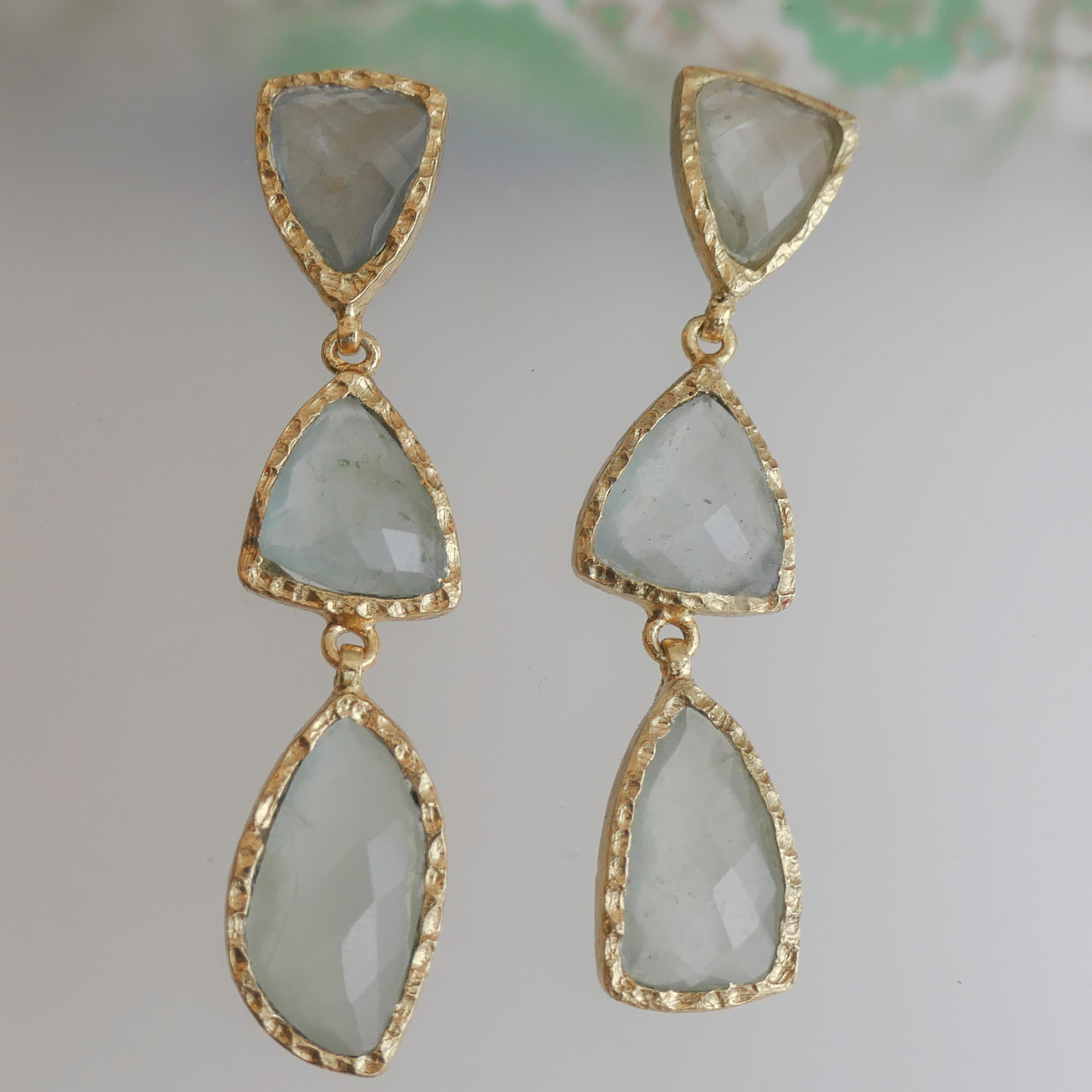 These faceted free form aquamarine gemstones are bezel set in  in gold plated sterling silver. These are a bold pair of earrings.
Length is 5.5cm