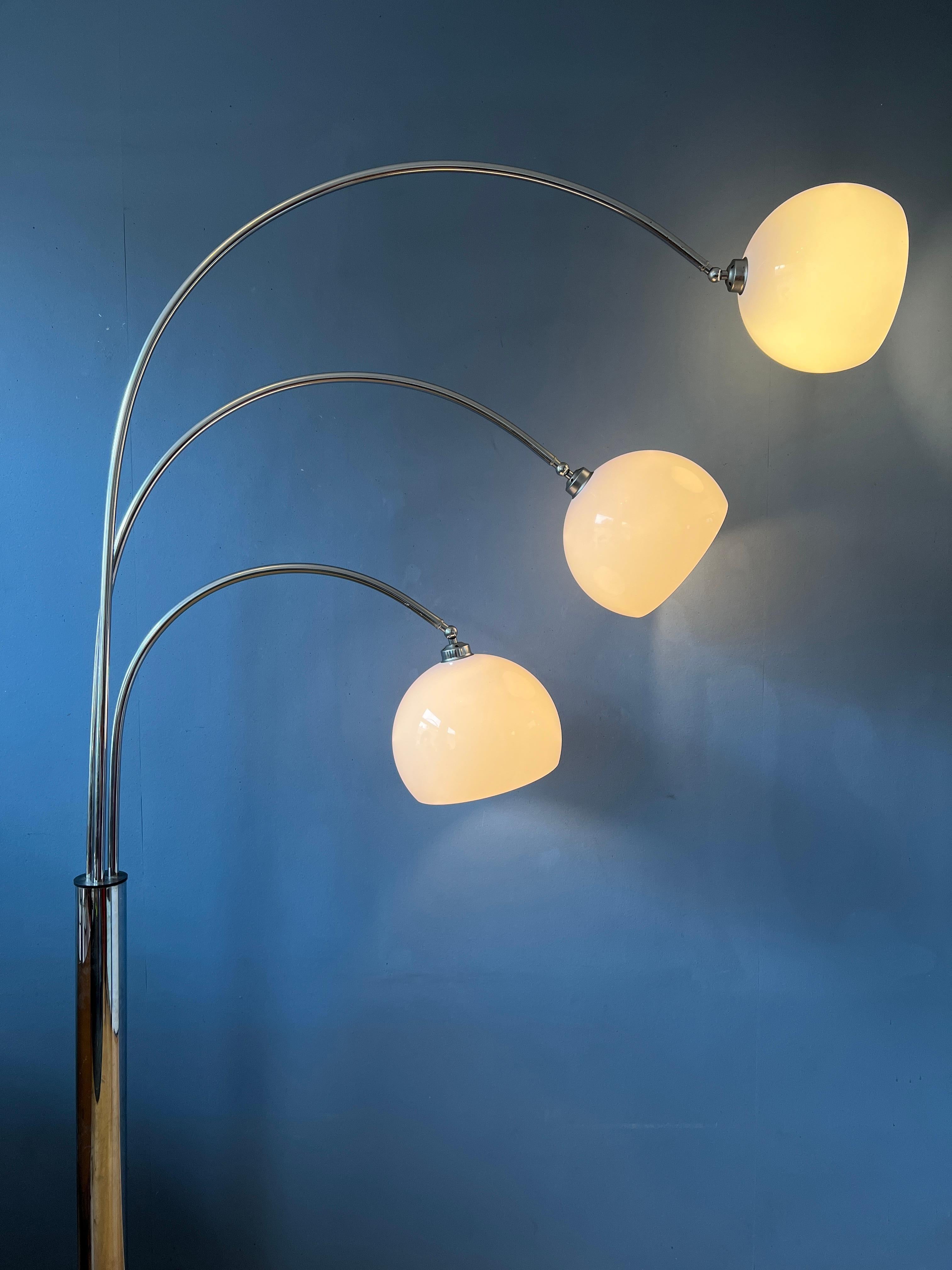 Big, majestic triple arc floor lamp by Goffredo Reggiani for Guzzini. All arcs can be positioned in different directions and the shades can be fixated upwards or downwards. The lamp requires three E27 lightbulbs and currently has an EU-plug.

The