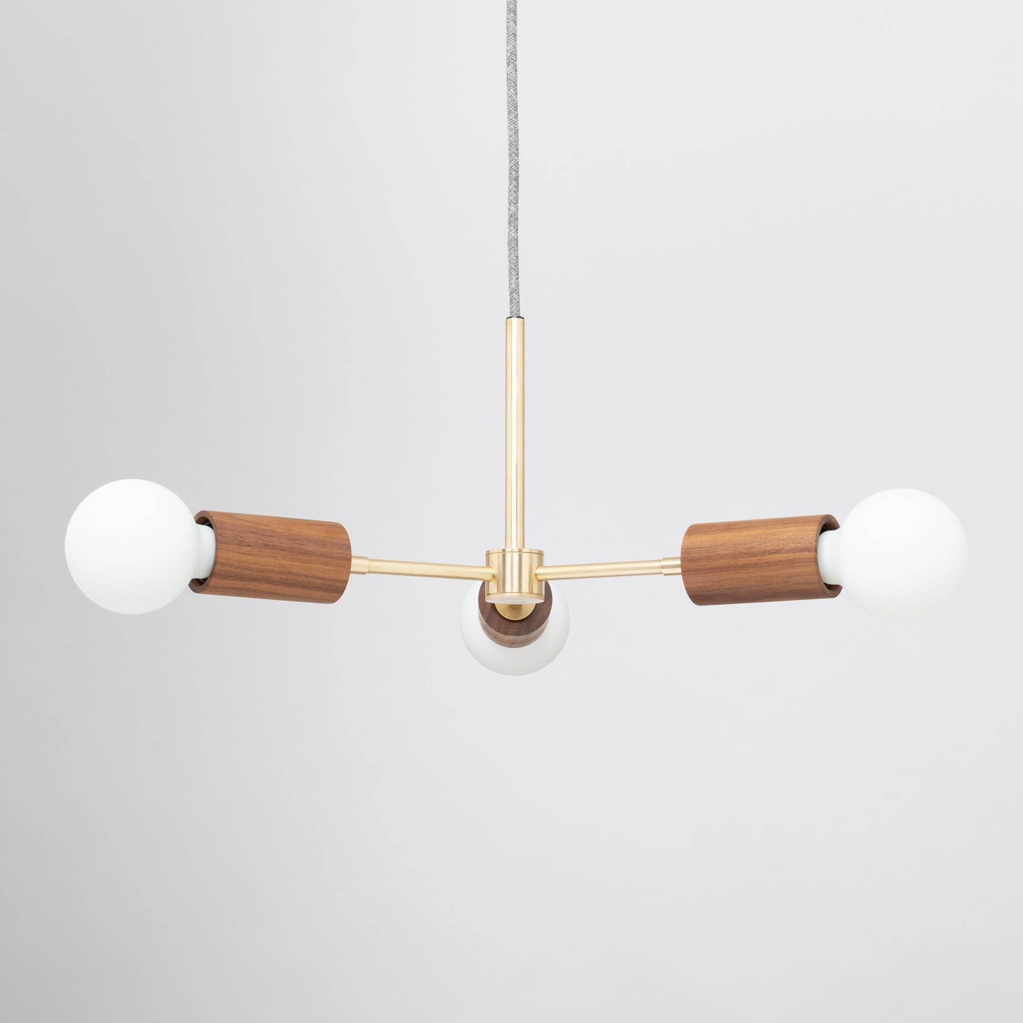 Triple Arm Walnut Pendant
Oak or Walnut options available 
2000K - 2800K 95CRI
1800 Dim to Warm Lumens
Sphere III bulbs included
Satin Brass lacquered finish
Fabric cable 
Custom drop from ceiling supplied
Handcrafted in UK. 
