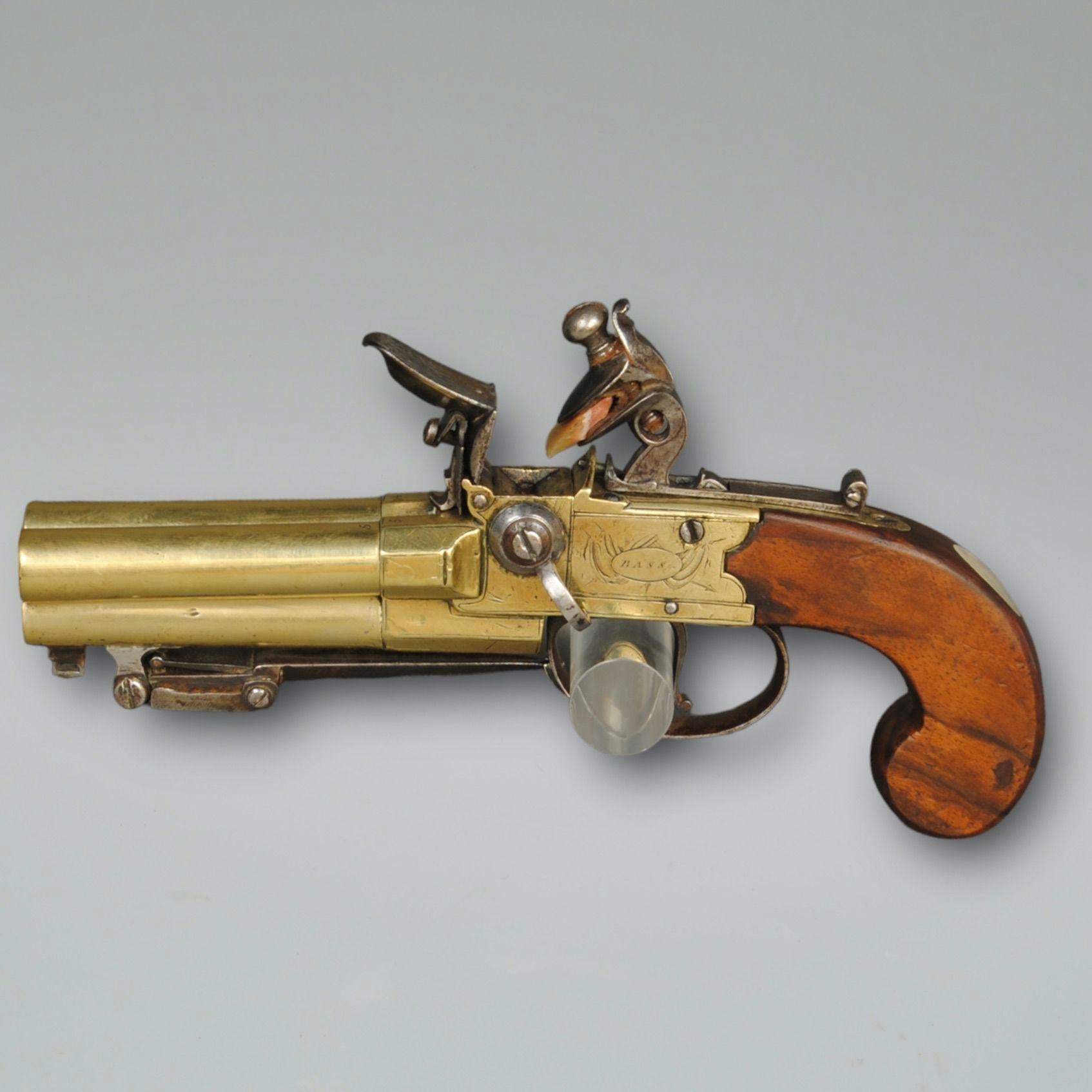 A rare late 18th century triple barrel boxlock, tap action pocket pistol by Bass, London, with bayonet below the middle barrel 
Proof marks next to sliding trigger to release the bayonet.
Barrel length 7cm