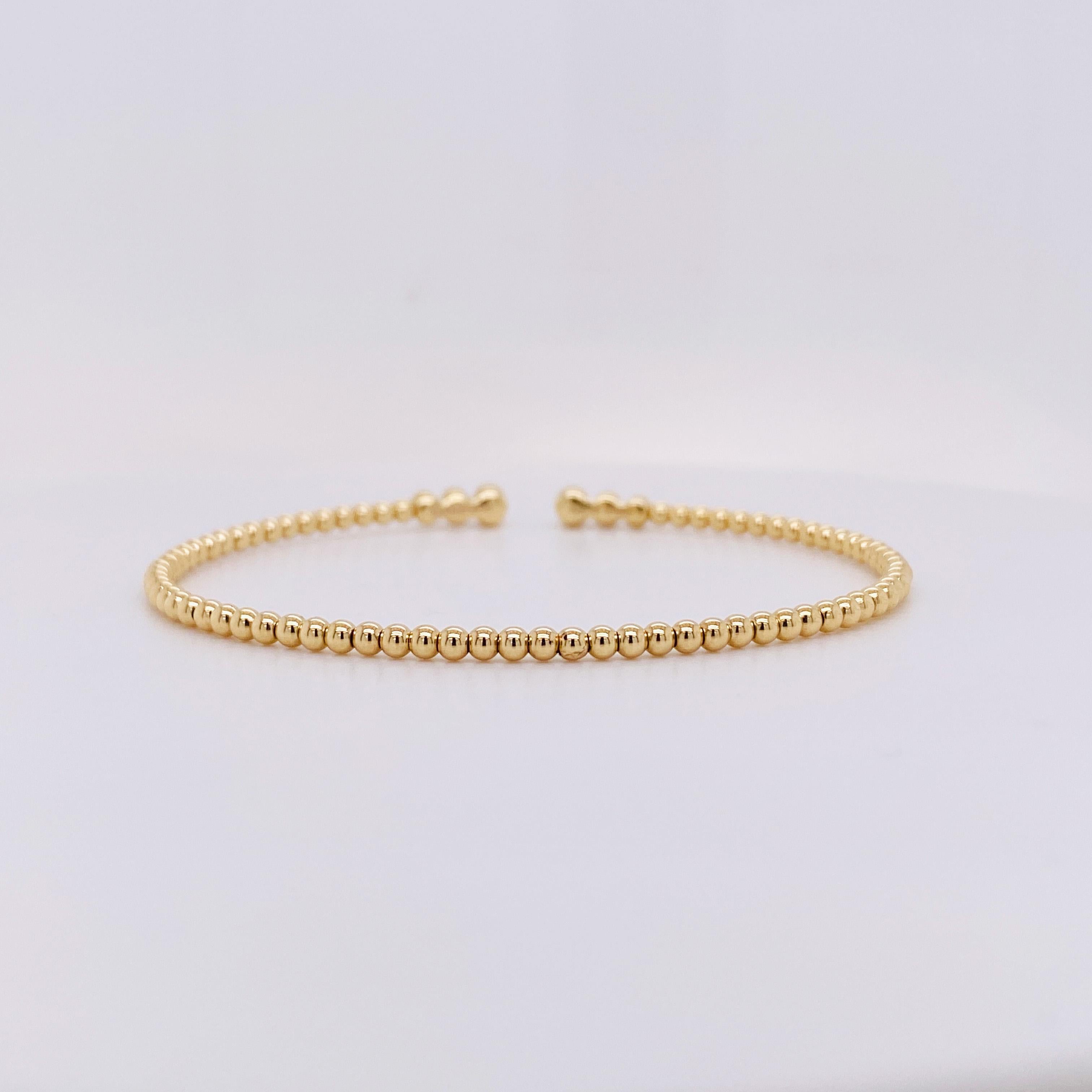 This fun designer diamond flex bracelet looks great on everyone! Three round diamonds sit in modern bezel settings accent the top adding the perfect amount of sparkle for dressing up or dressing down. The bracelet is 14 karat yellow gold and