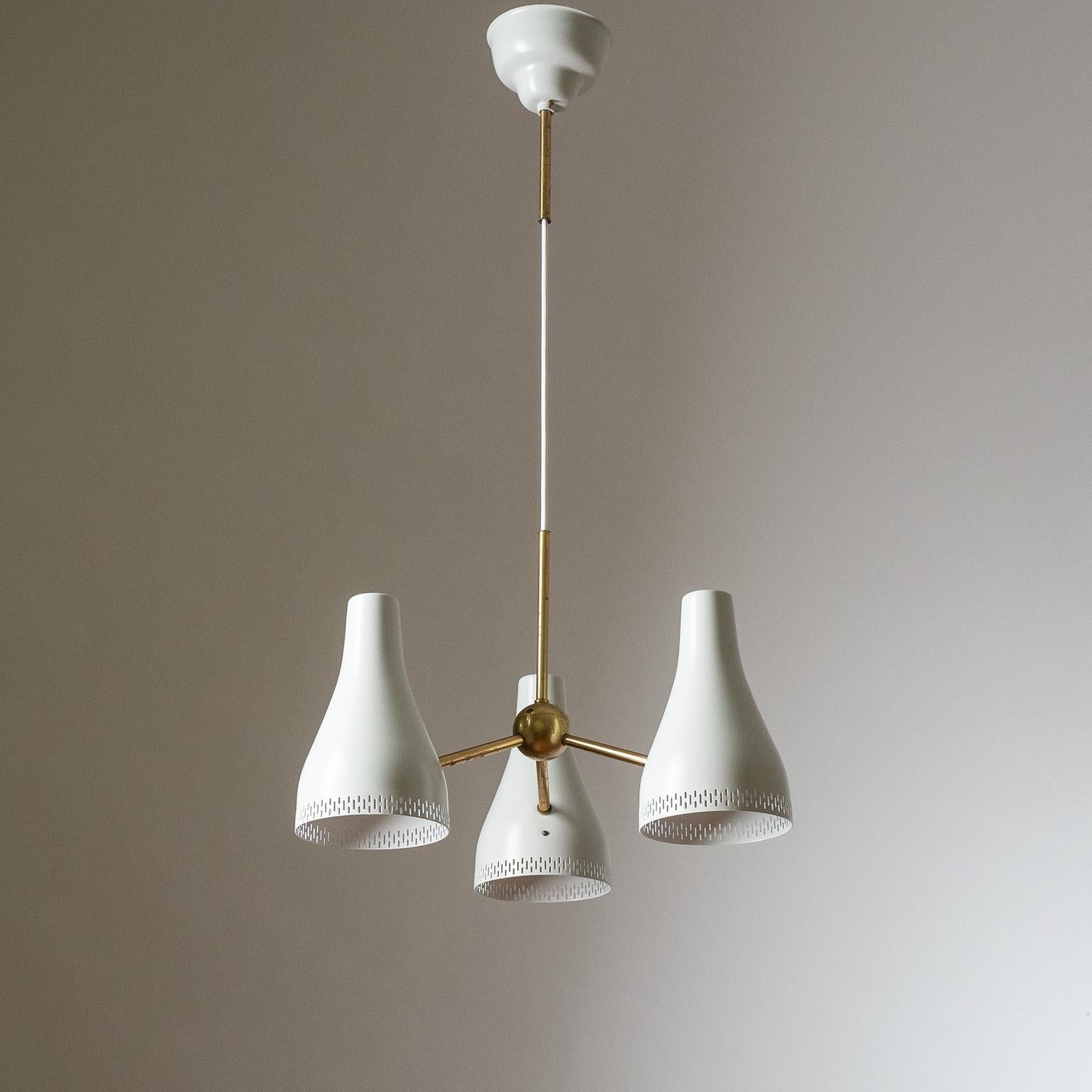 Rare three-cone pendant designed by Hans Bergström for ASEA in the 1950s. Emanating from a small brass globe are three lacquered aluminum cones with three rows of perforations each. The cones and canopy have been professionally repainted in their