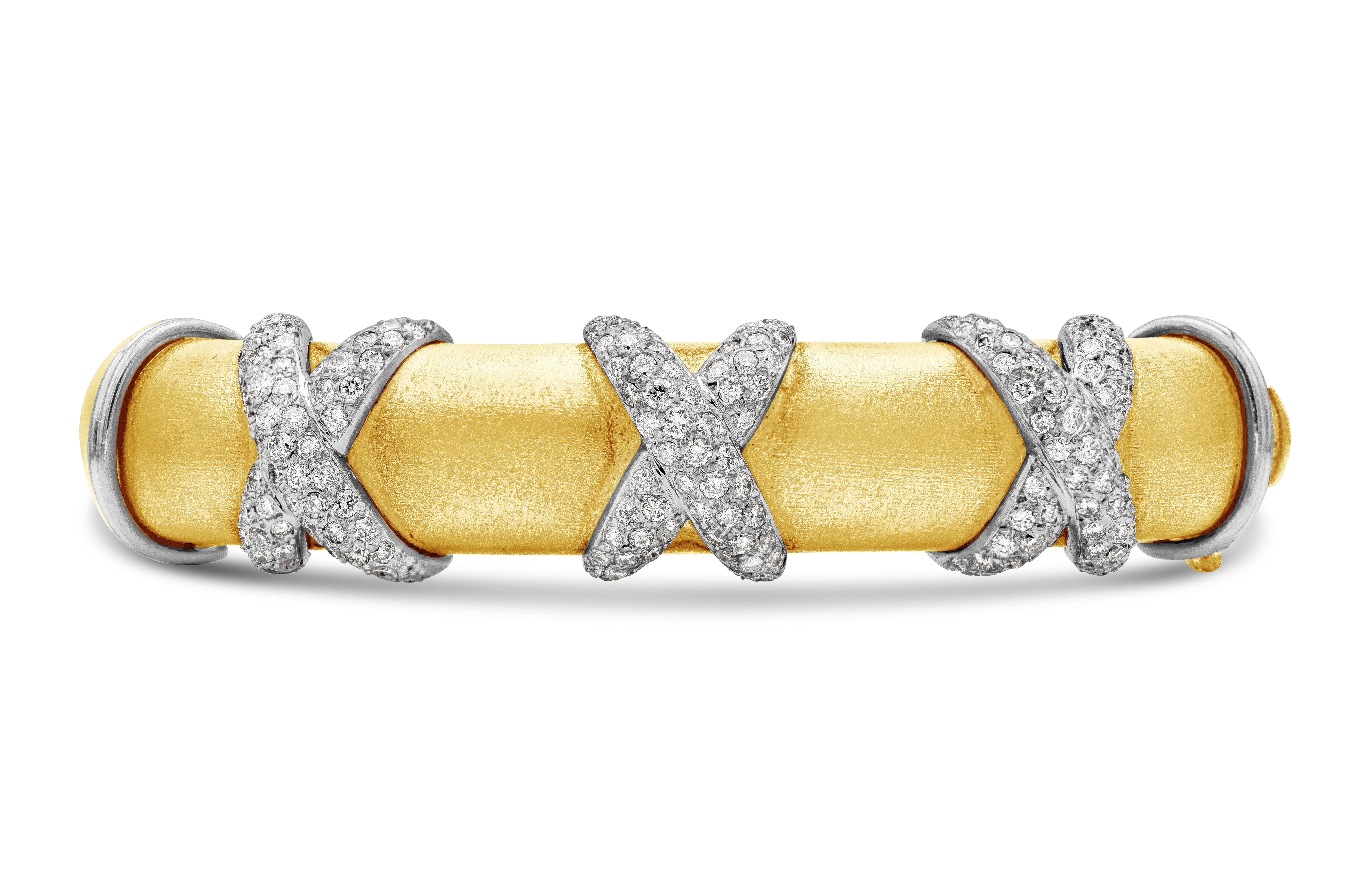 Showcasing a striking bangle bracelet made in 18k yellow gold and set in a three X's micro pave design with diamonds wrap around the front of the bracelet weighing 2.50 carats total. A timeless piece of jewelry. Finely made in 18k white gold and